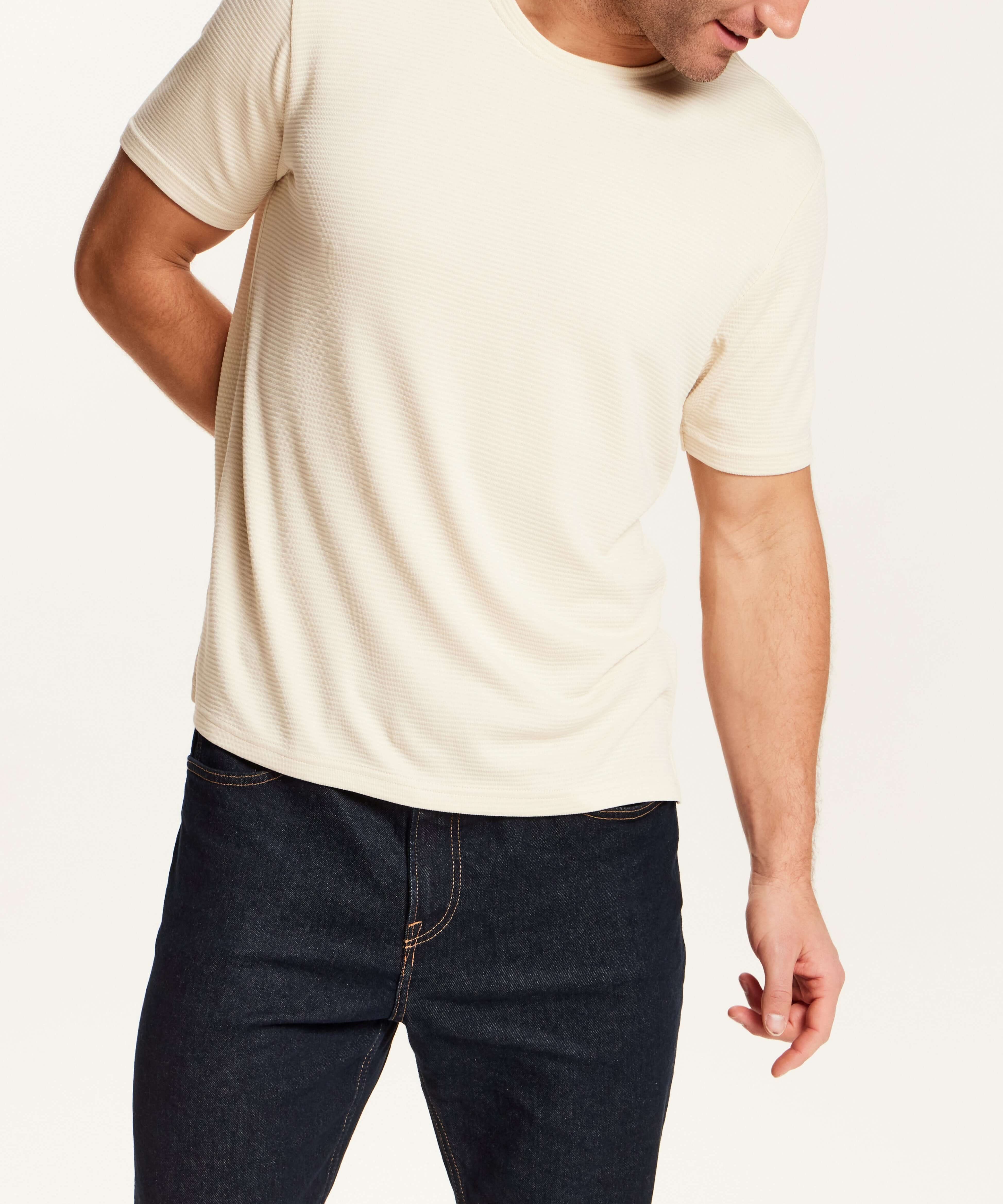 Horizontal Rib Tee in Cream worn by a model, featuring a soft modal blend and crew neckline.
