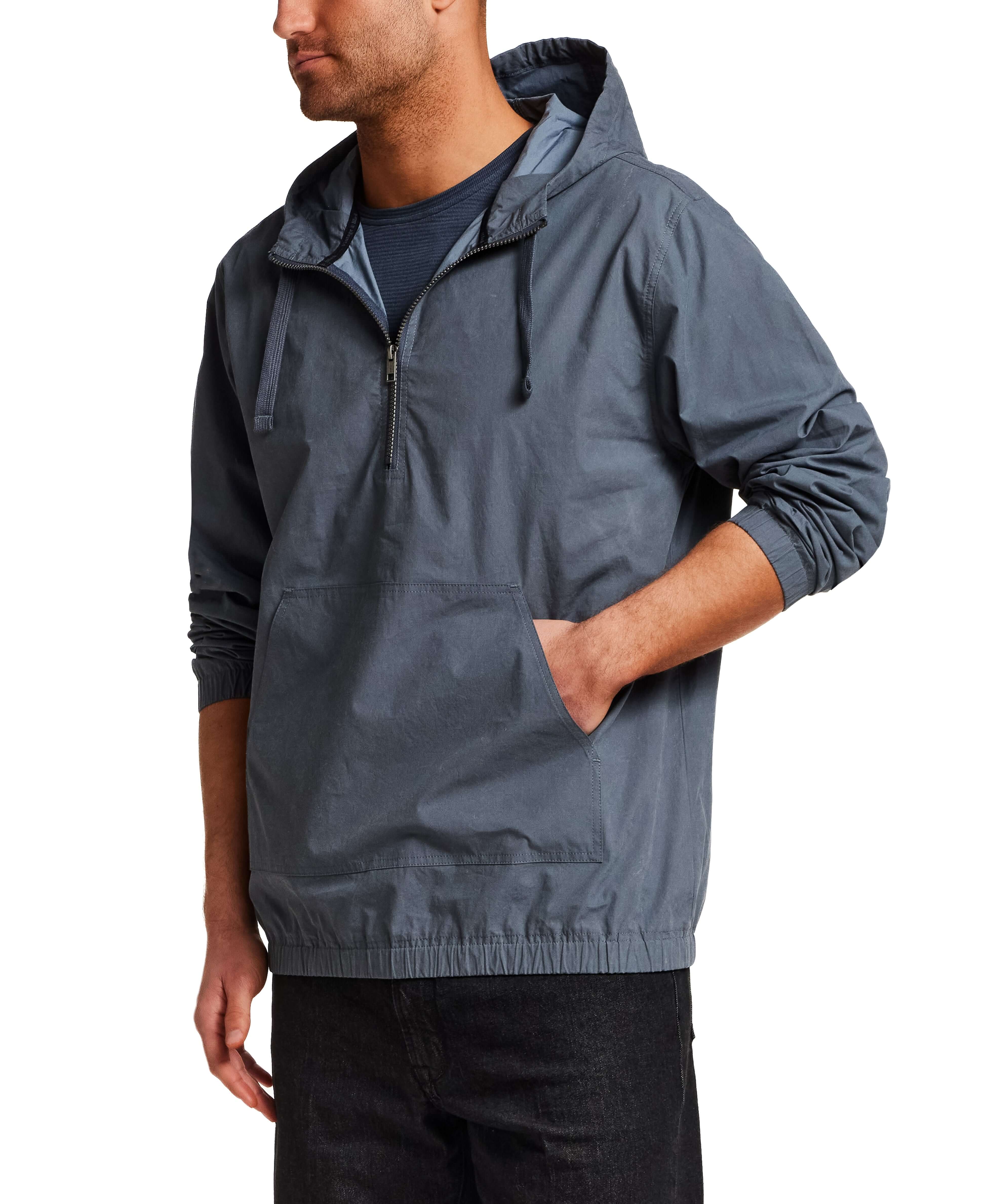 Distressed Poplin Hooded Pullover in Indigo worn by a man standing, featuring a half-zip front and front pouch pocket.