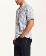 Floral Seersucker Shirt in White worn by a man, featuring a navy floral medallion print and a relaxed fit.