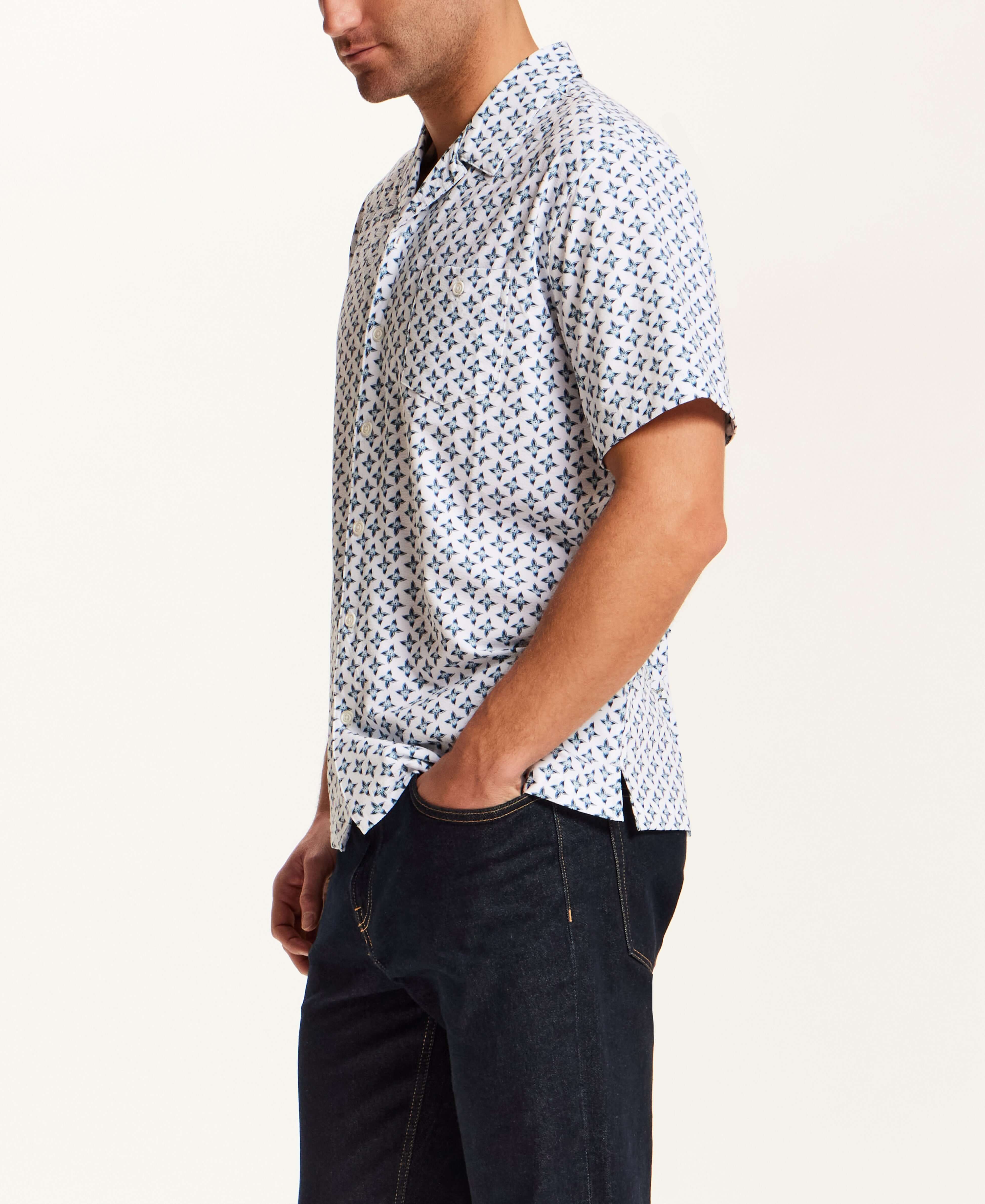 Floral Seersucker Shirt in White worn by a man, featuring a navy floral medallion print and a relaxed fit.