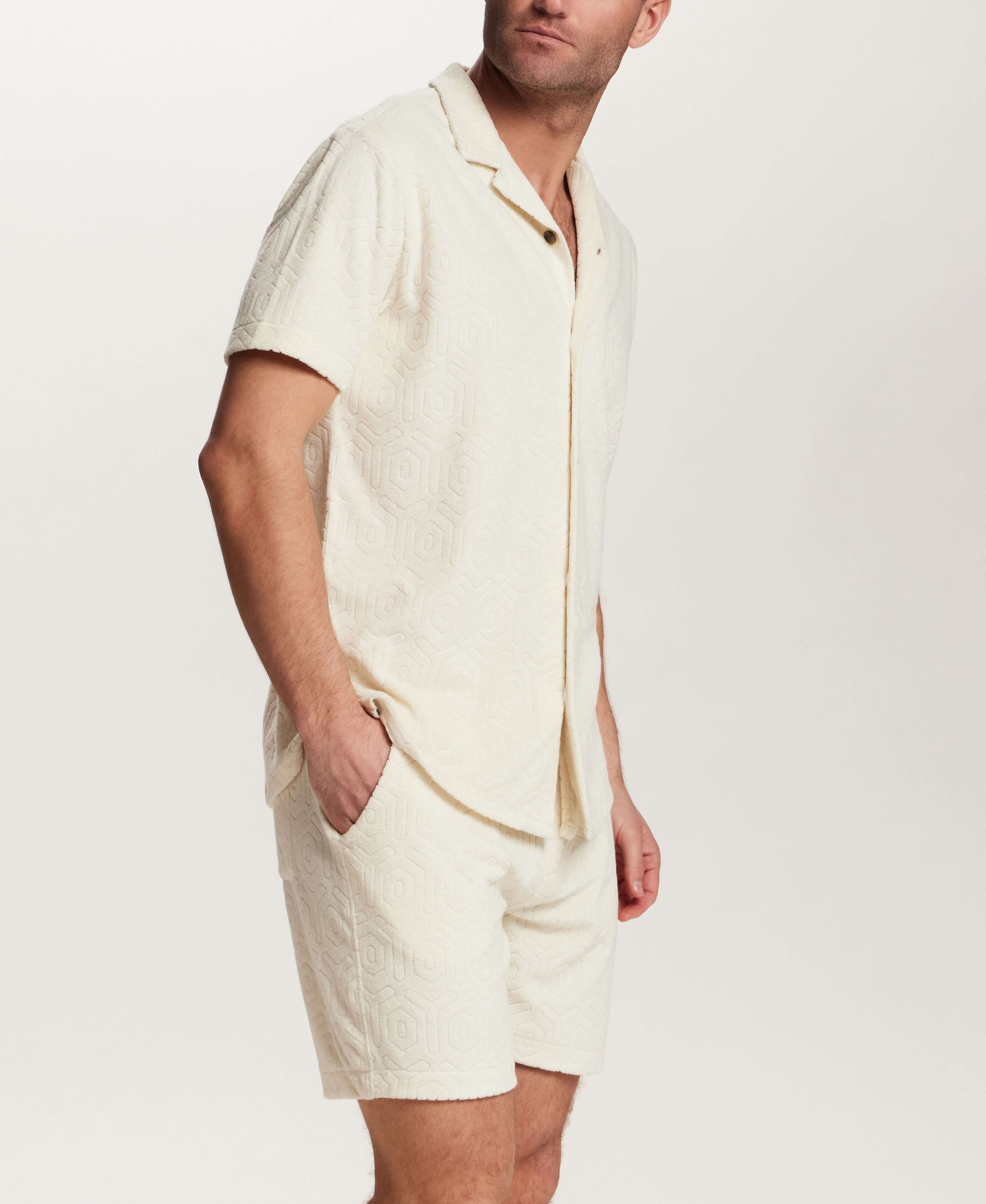 Geometric Terry Camp Shirt in Stone worn by a man with matching shorts, featuring soft fabric and a relaxed camp collar.