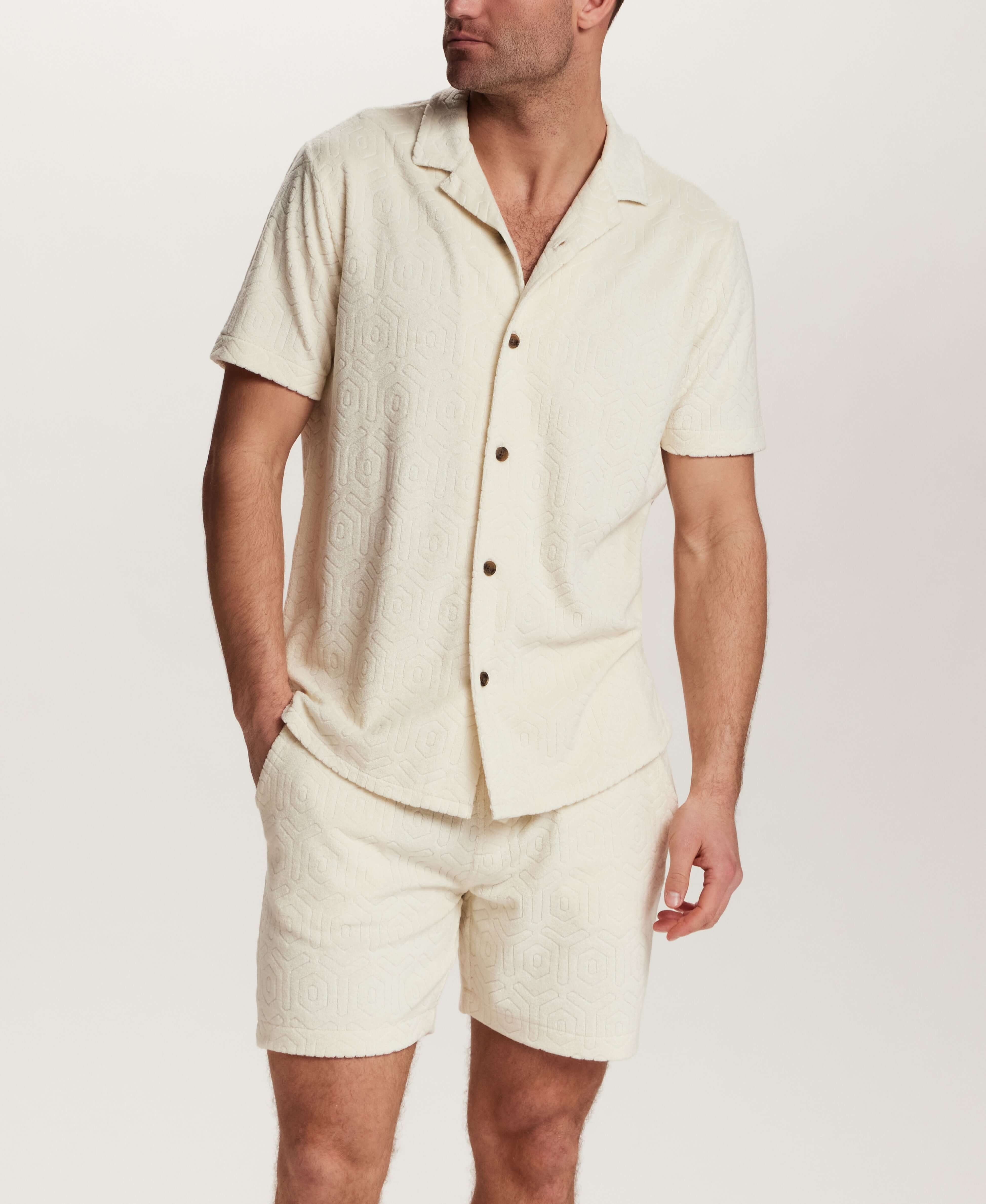 Model wearing Geometric Terry Camp Shirt in Stone with matching shorts, showcasing soft terry fabric and relaxed camp collar.