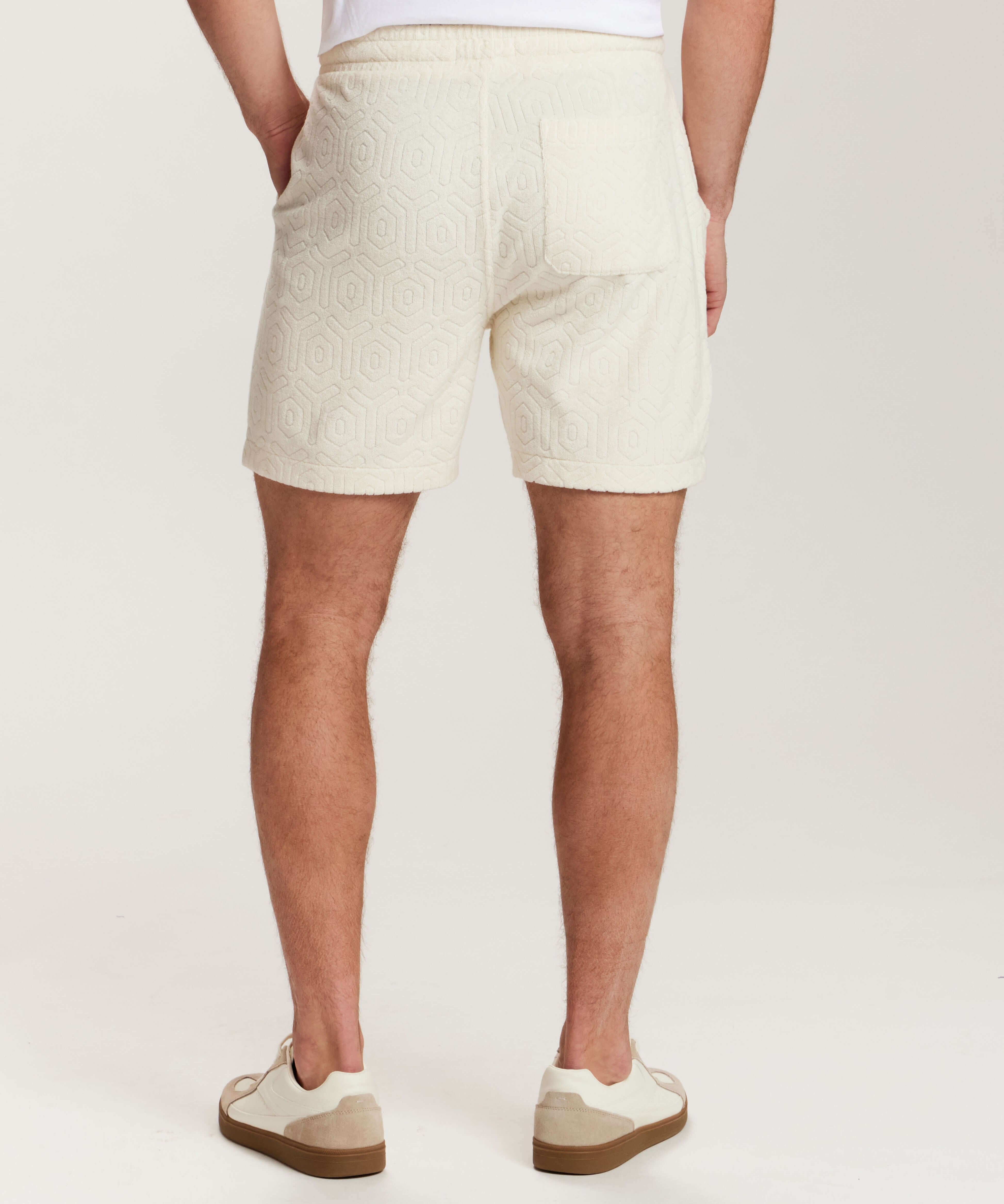 Geometric Terry Drawstring Short in Stone, showing back view with subtle geometric pattern and side slash pockets.