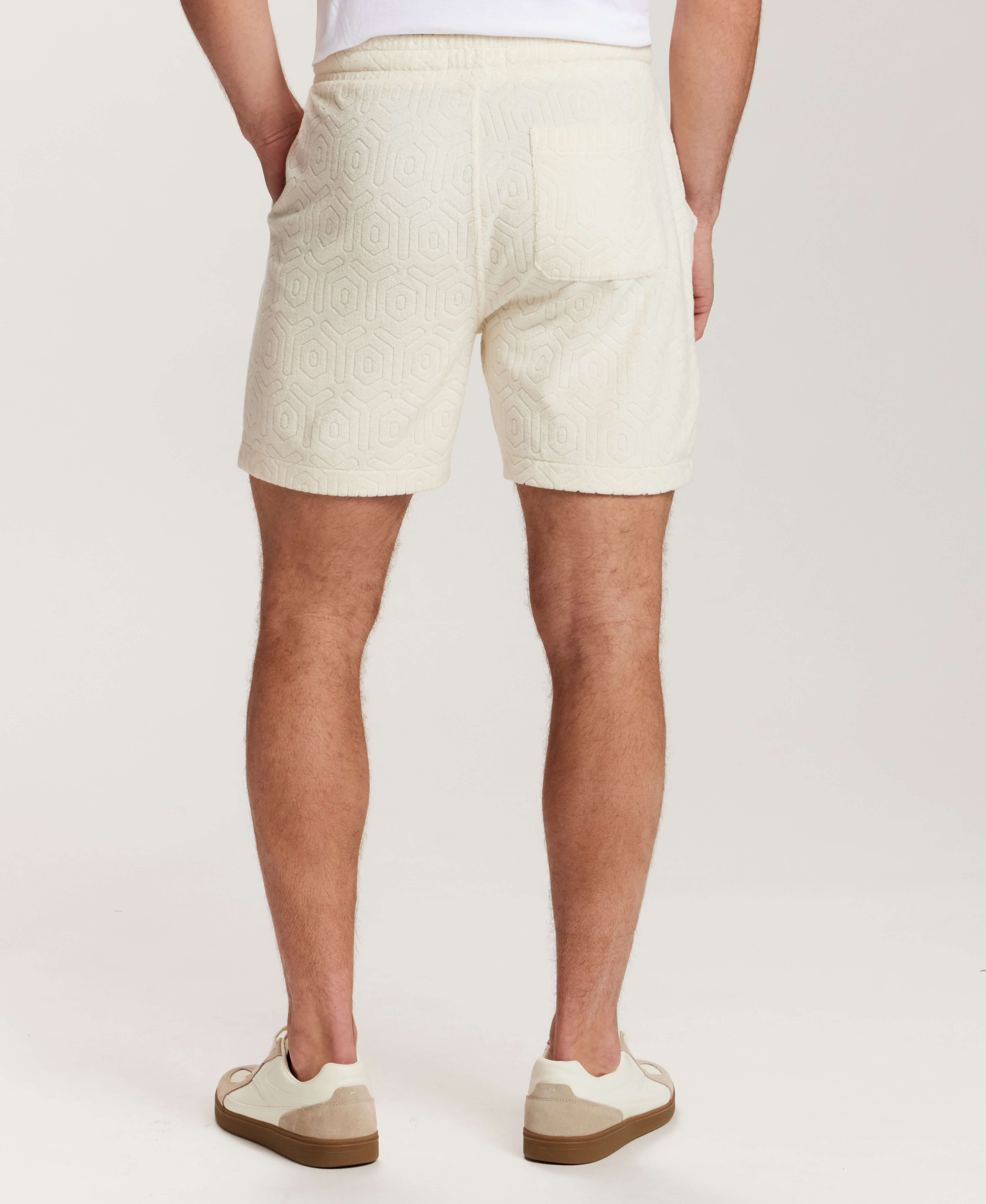 Geometric Terry Drawstring Short in Stone, showing back view with subtle geometric pattern and side slash pockets.