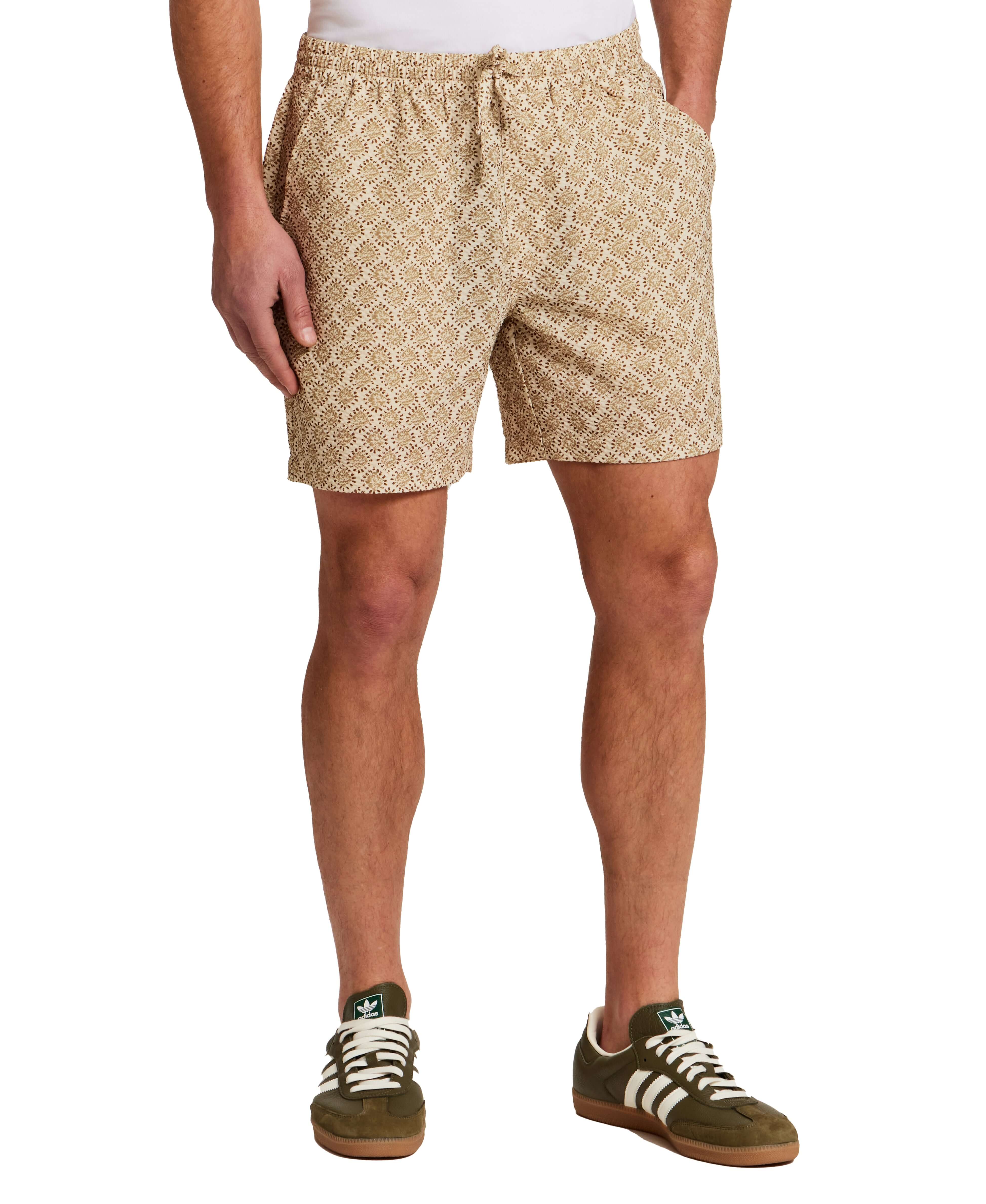 The Medallion Print Seersucker Short in Khaki worn by a model standing, showcasing the elastic waistband and floral pattern.