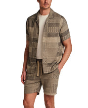 The Patchwork Jacquard Short in Khaki worn with a matching shirt, featuring a woven patchwork jacquard design.