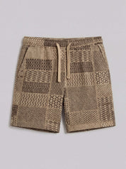 The Patchwork Jacquard Short in Khaki featuring a woven patchwork design and elastic waistband with drawstring.