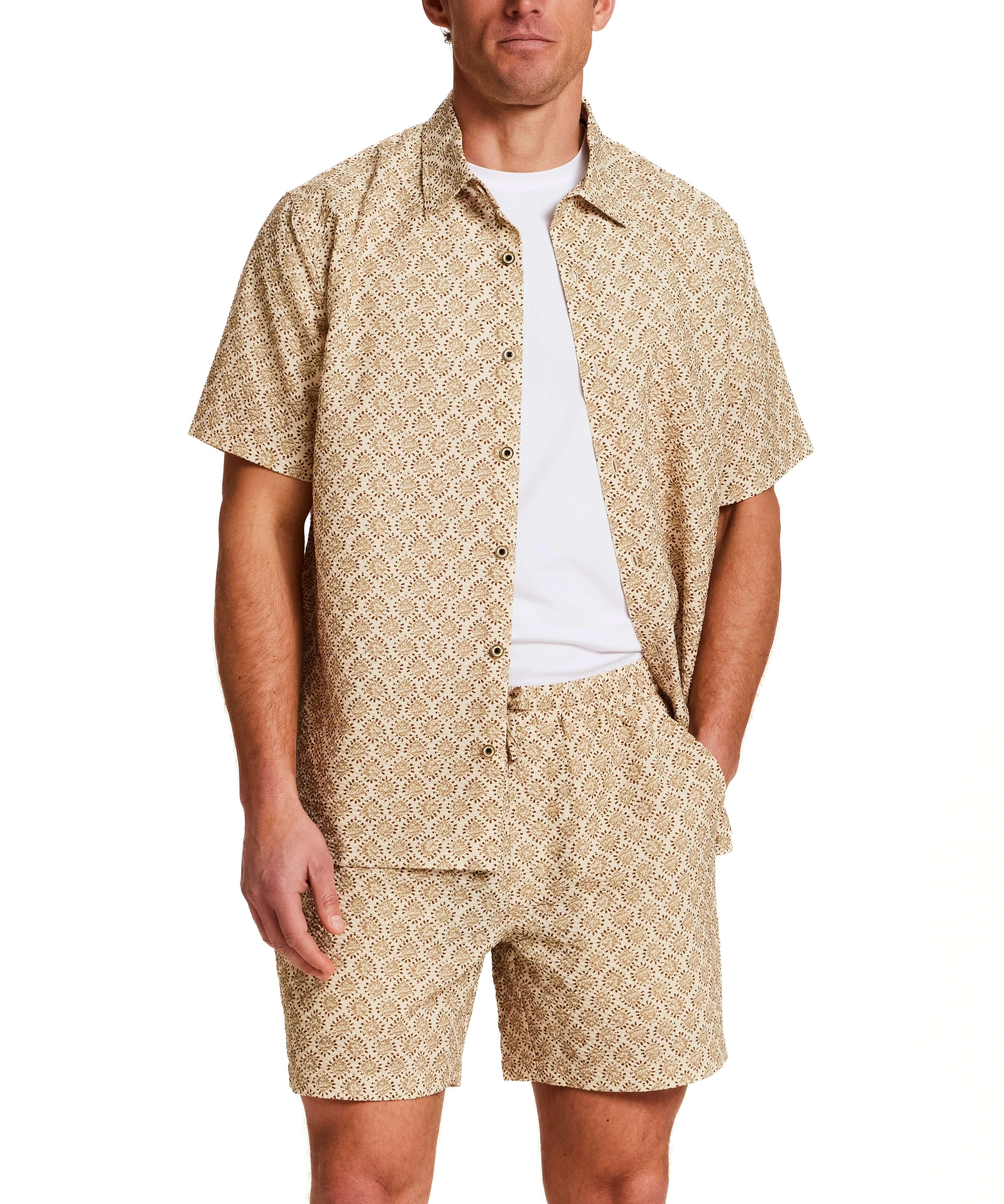 The Medallion Print Seersucker Shirt in Khaki worn by a male model, showcasing a stylish short sleeve and matching shorts.