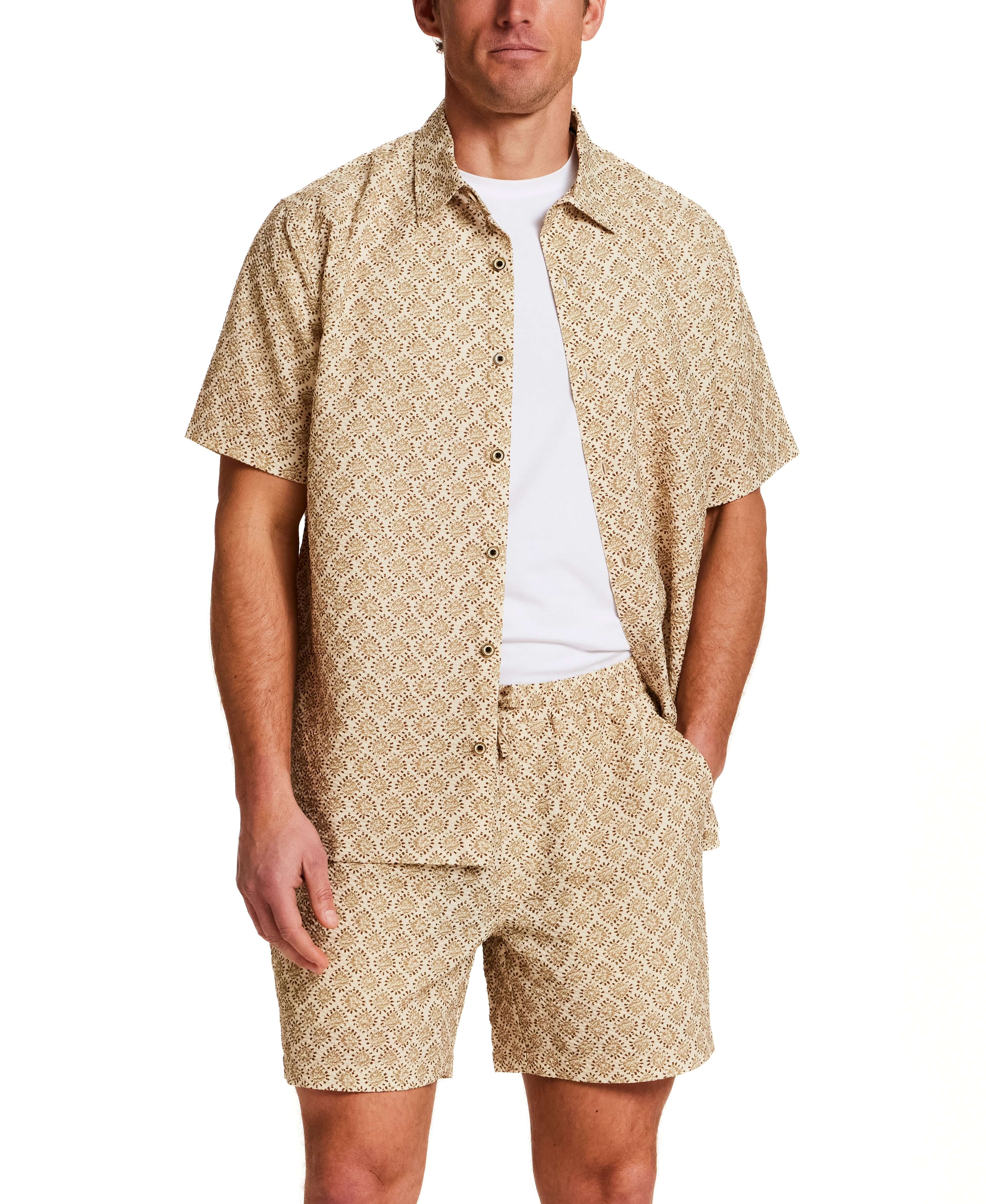The Medallion Print Seersucker Shirt in Khaki worn by a male model, showcasing a stylish short sleeve and matching shorts.