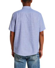 Back view of a man wearing a Linen Blend Dobby Stripe Shirt in Infinity Blue with short sleeves and button-down collar.