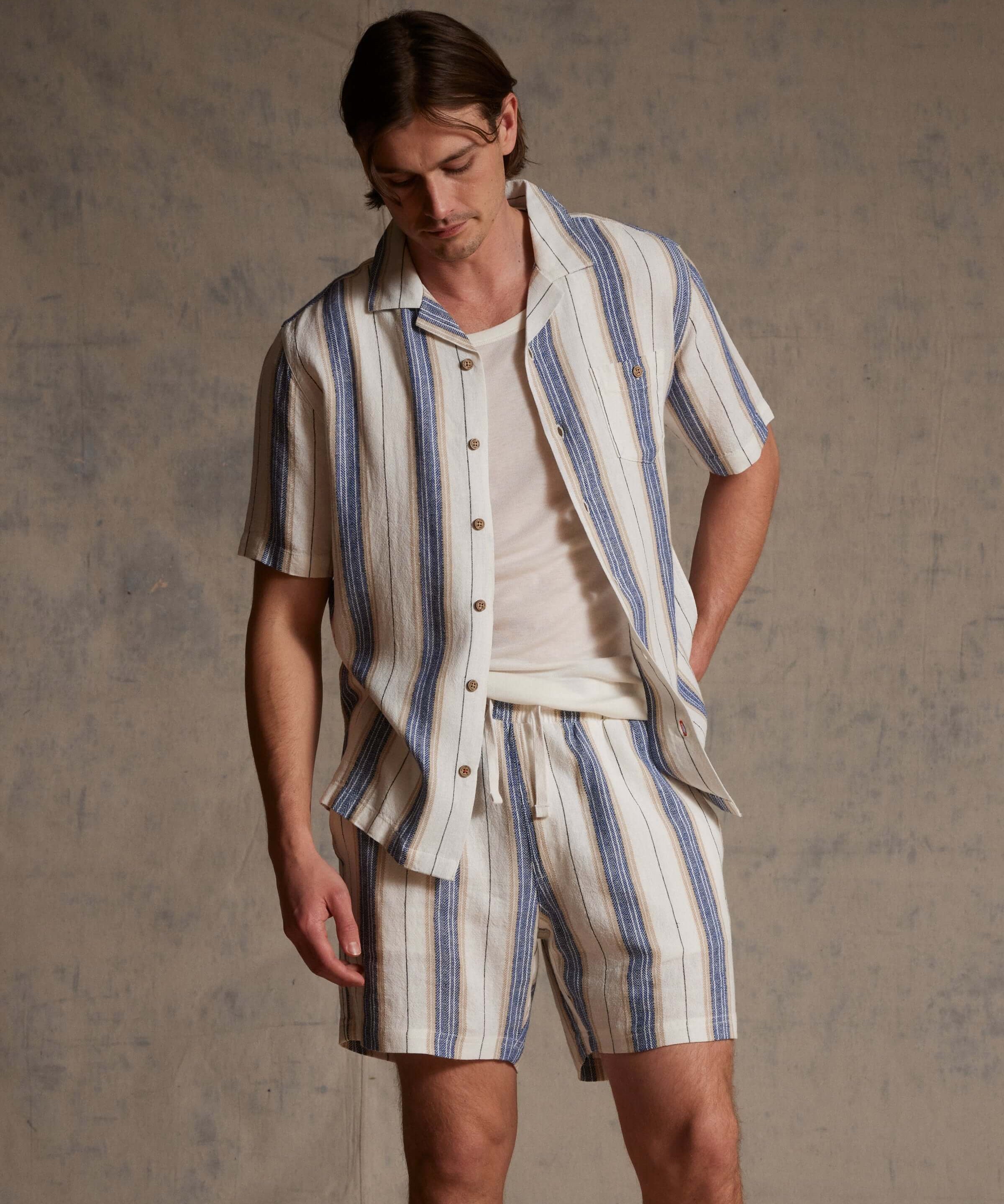 Linen Blend Vertical Stripe Shorts in Blue White Stripe worn with matching top, featuring vertical stripes and elastic waist.