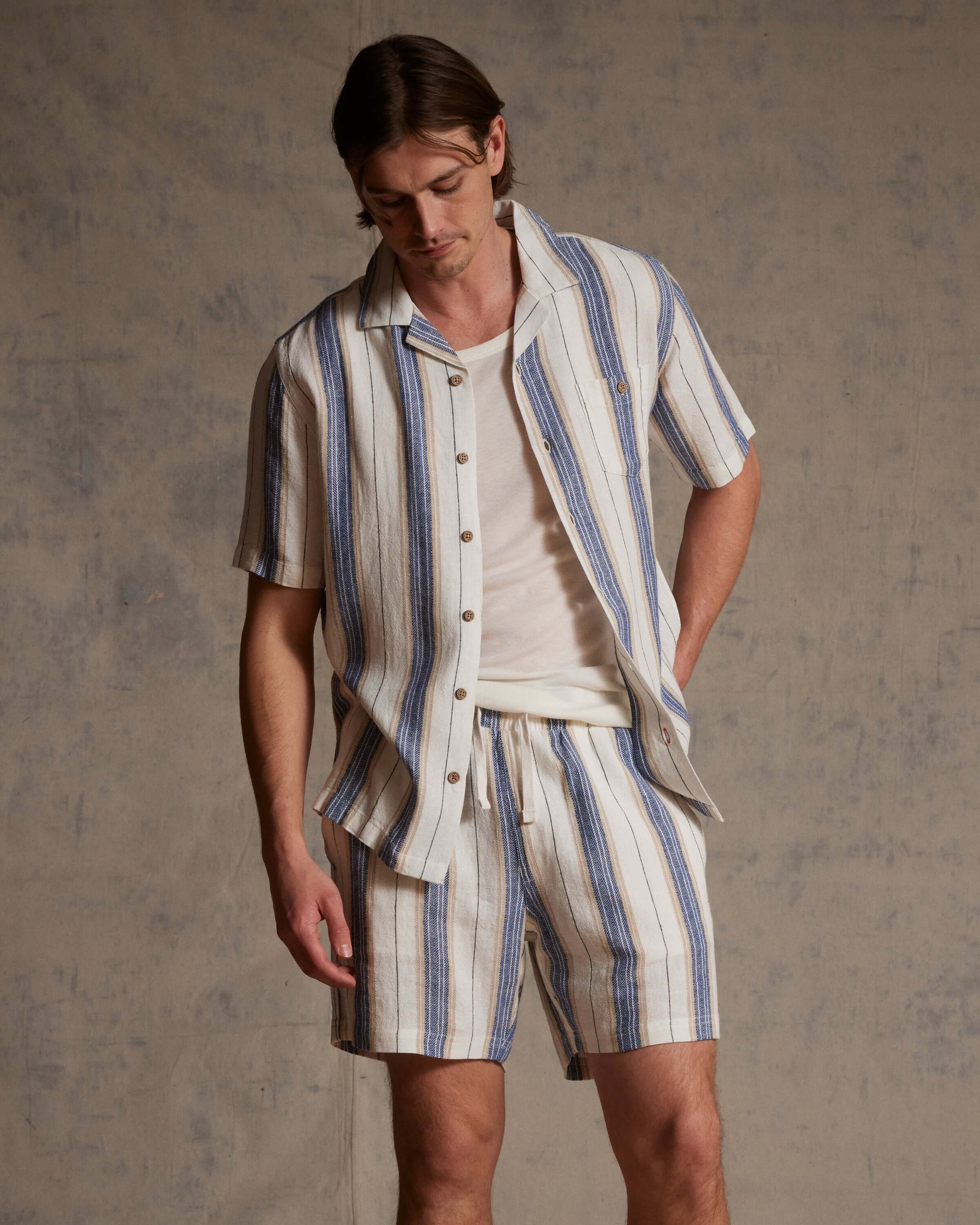 Linen Blend Vertical Stripe Shorts in Blue White Stripe worn with matching top, featuring vertical stripes and elastic waist.