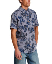 The Linen Cotton Print Shirt in Dress Blue modeled by a man wearing a button-down shirt with an abstract floral print.