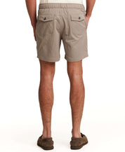 Model wearing Mini Seersucker Short in Khaki from the back, showcasing the elastic waistband and pockets.