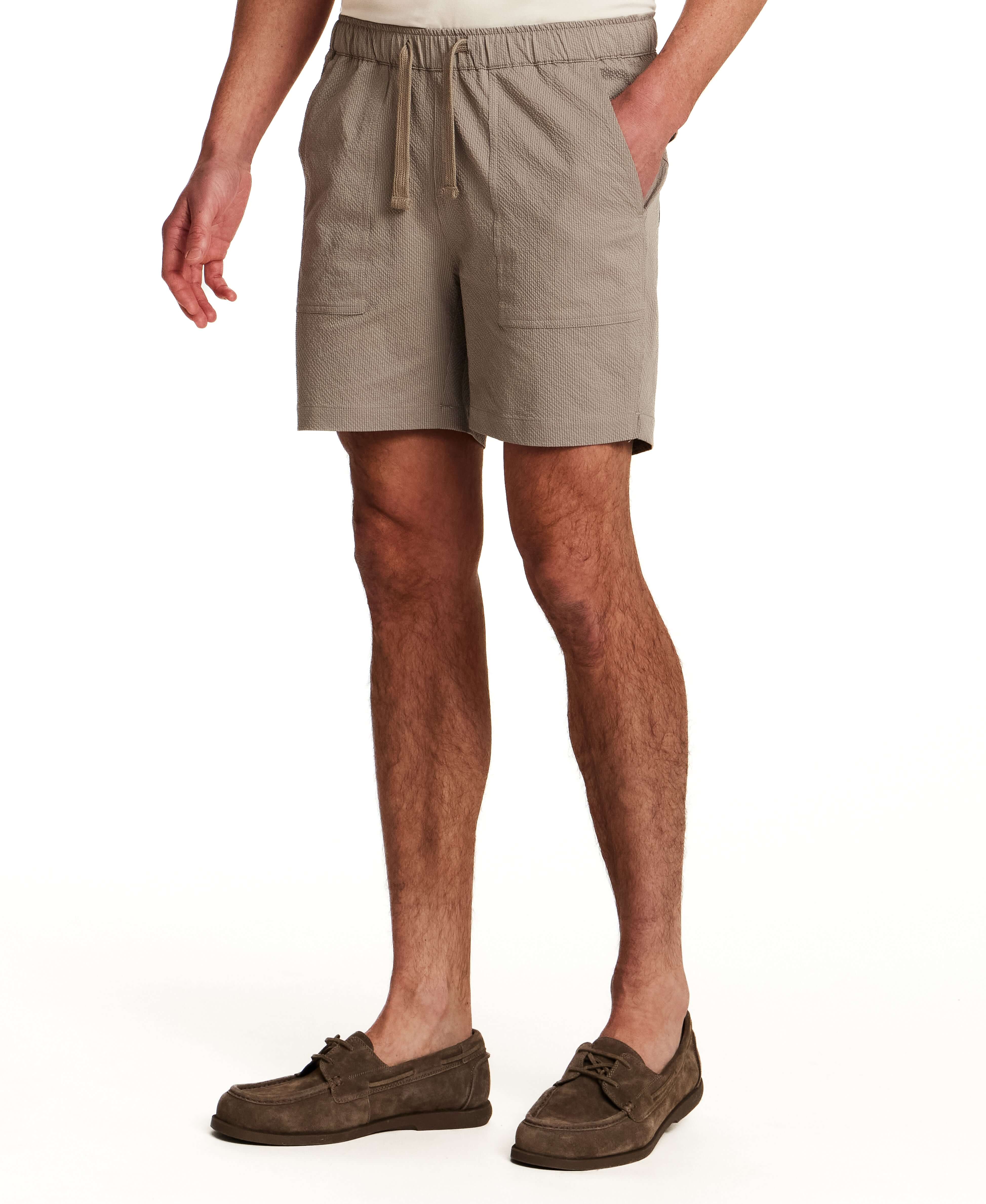Mini Seersucker Short in Khaki shown on model, featuring elastic waistband and 6" inseam for a refined look.