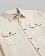 The Utility Shirt in Natural featuring a clean design, button front, and flap chest pockets for everyday wear.