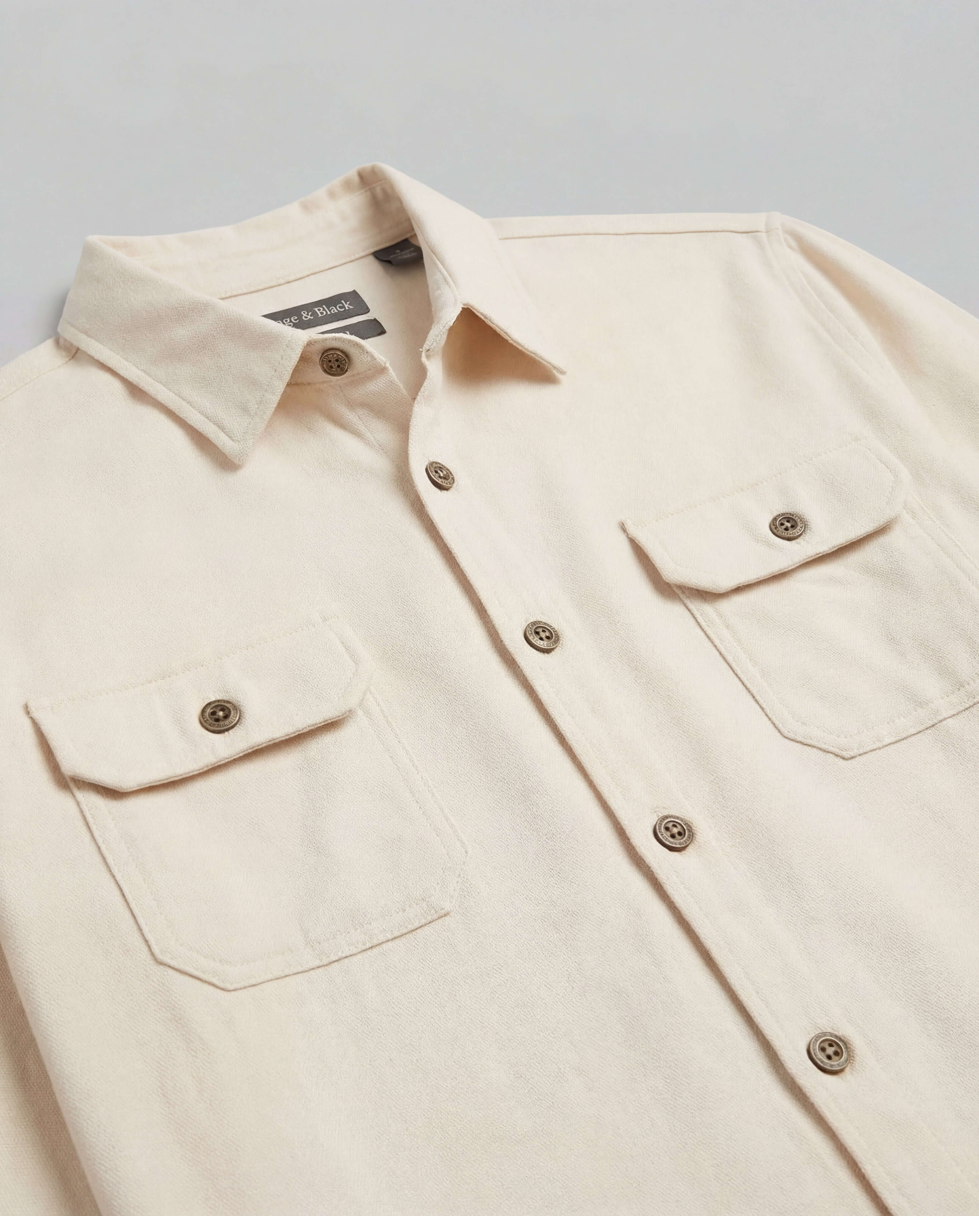 The Utility Shirt in Natural featuring a clean design, button front, and flap chest pockets for everyday wear.