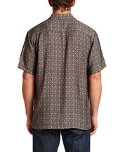 Back view of a man wearing a Petal Print Short-Sleeve Shirt with intricate design and short sleeves.