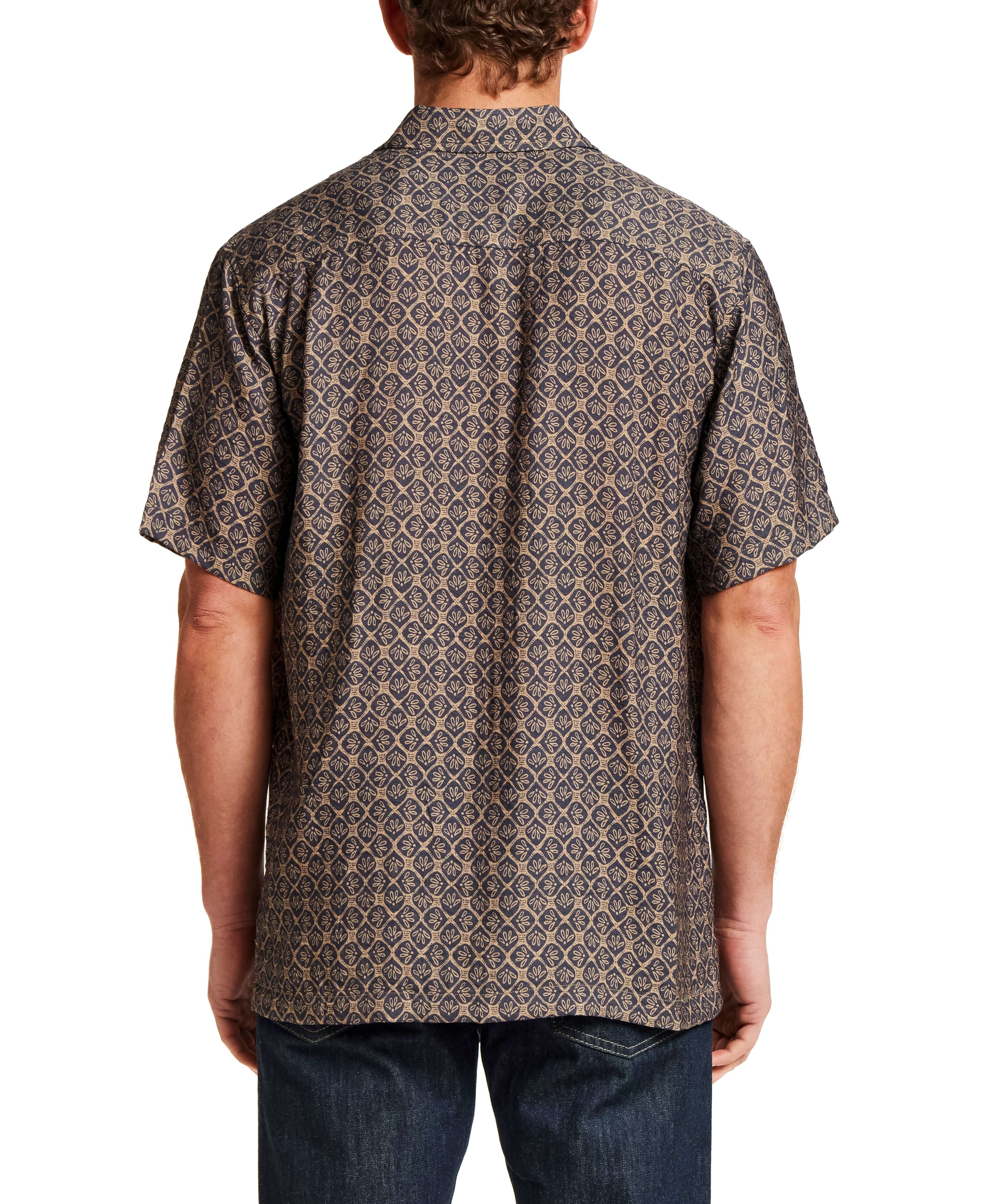 Back view of a man wearing a Petal Print Short-Sleeve Shirt with intricate design and short sleeves.