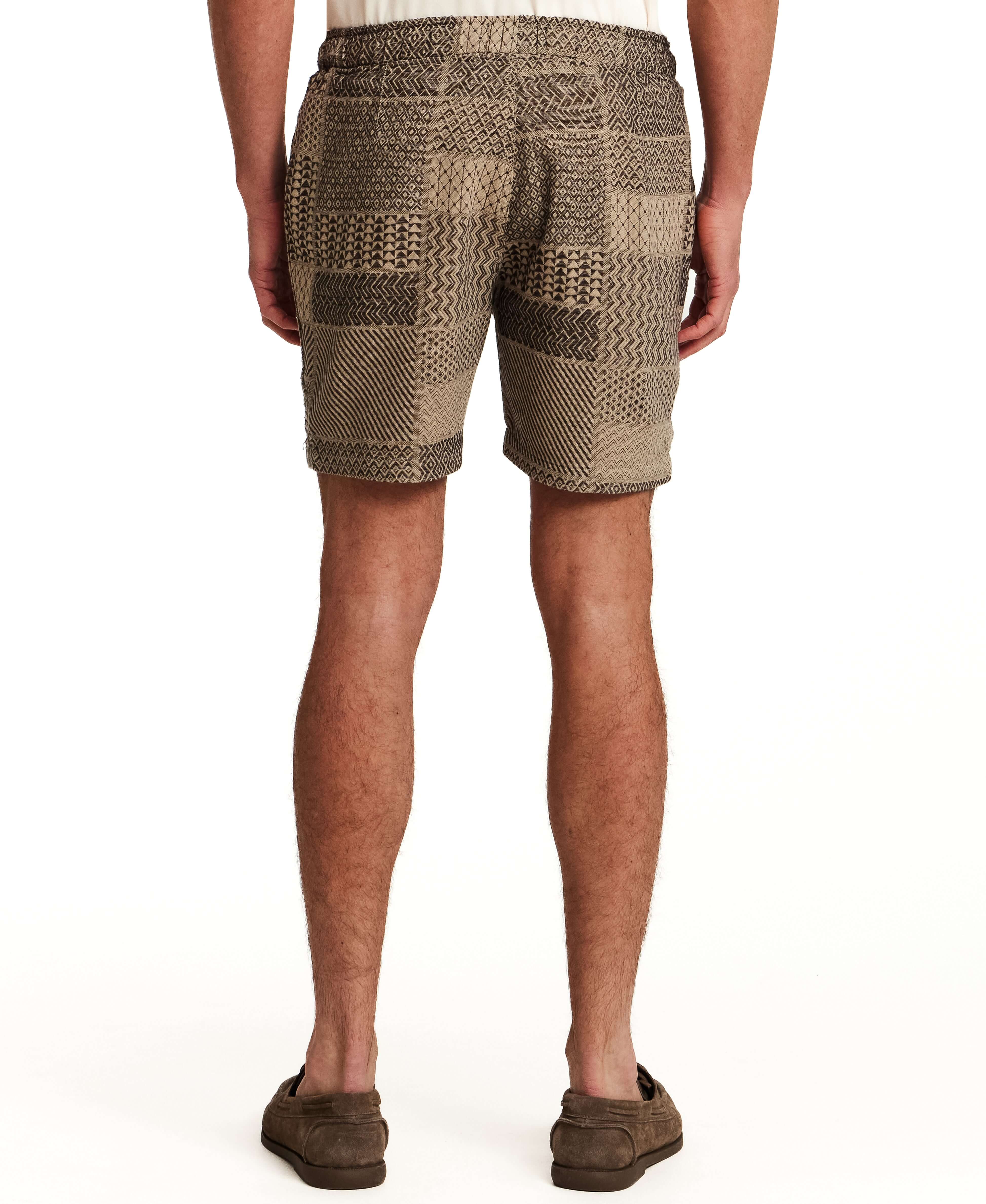 The Patchwork Jacquard Short in Khaki displayed from the back, showcasing its woven design and elastic waistband.