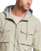 Poly Memory Safari Jacket with Hood in Sea Grass worn by a model, featuring an attached hood and full zip front.