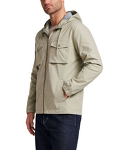 Poly Memory Safari Jacket with Hood in Sea Grass worn by model, featuring a hood and front pockets.
