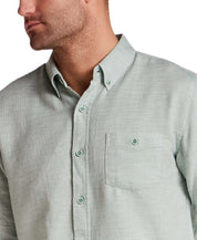 Pebble Dobby Button-Down Shirt in Sea Grass displayed on a model, highlighting its textured fabric and button details.