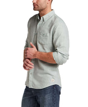 Pebble Dobby Button-Down Shirt in Sea Grass modeled by a man with long sleeves and a chest pocket.