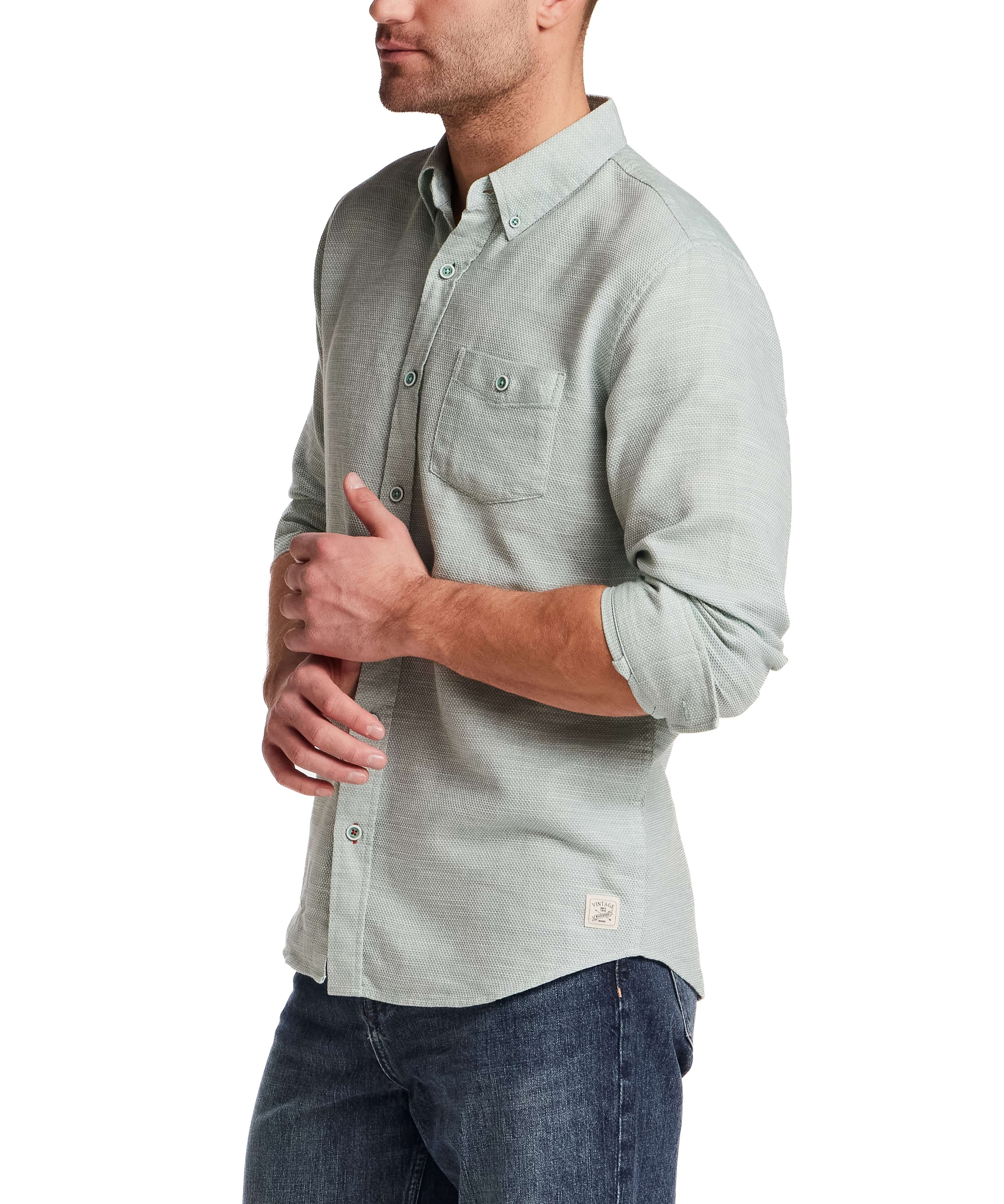 Pebble Dobby Button-Down Shirt in Sea Grass modeled by a man with long sleeves and a chest pocket.