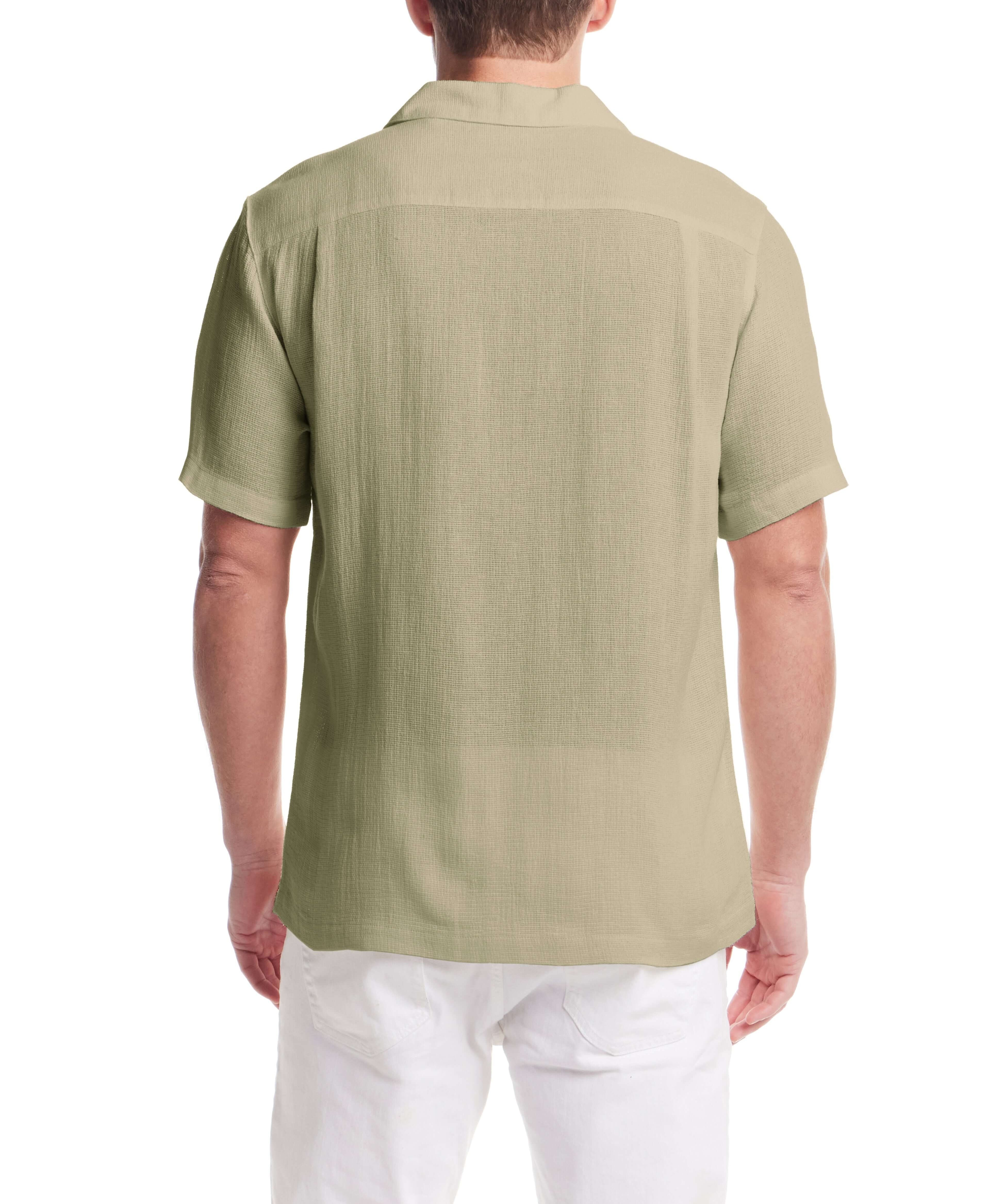 Back view of a man wearing a Short Sleeve Cotton Linen Airtex Shirt in Sea Grass, showcasing its camp collar and straight hem.