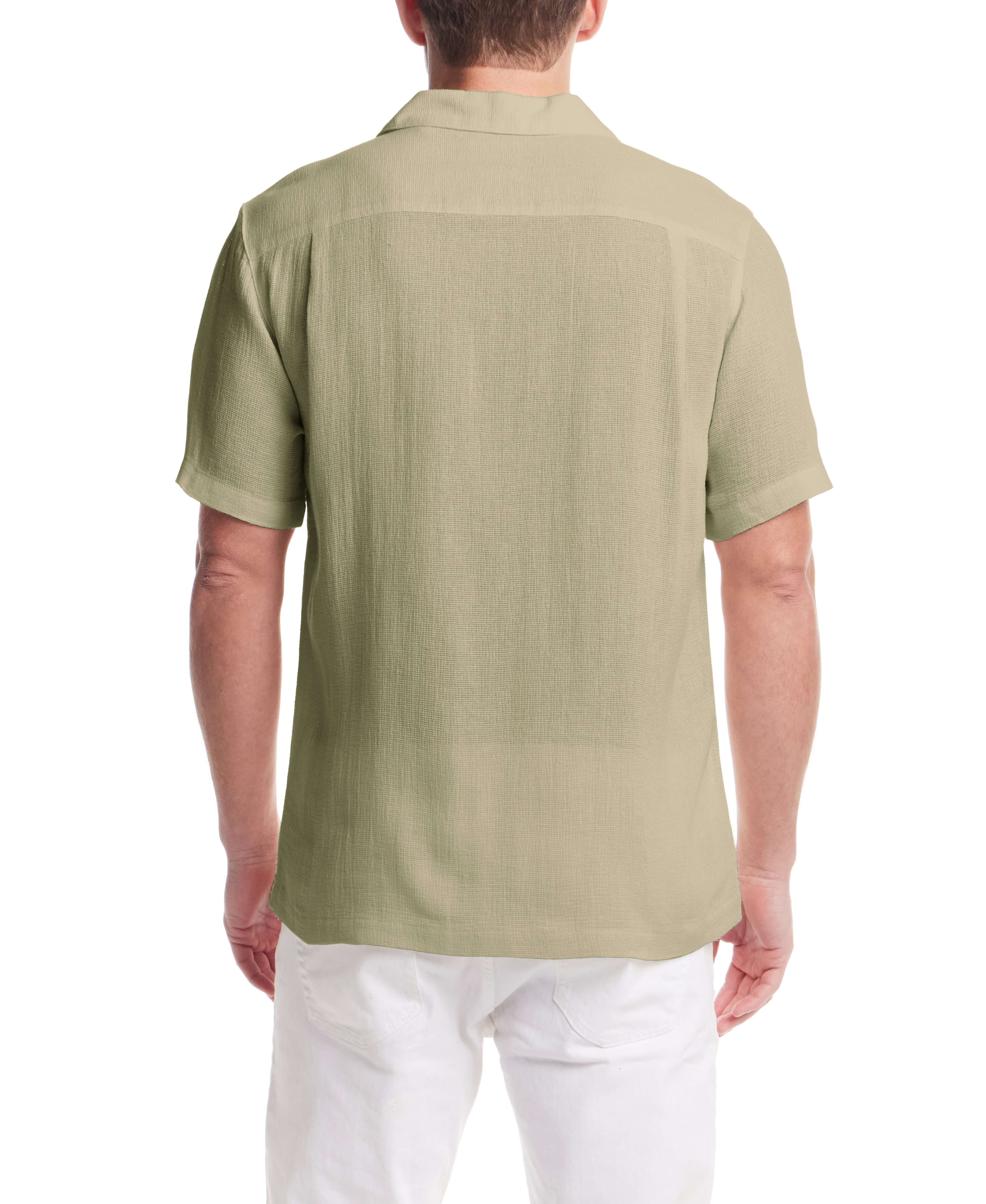 Back view of a man wearing a Short Sleeve Cotton Linen Airtex Shirt in Sea Grass, showcasing its camp collar and straight hem.