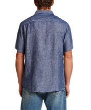 Back view of a man wearing a Short Sleeve Linen Shirt in Navy with short sleeves and a spread collar.