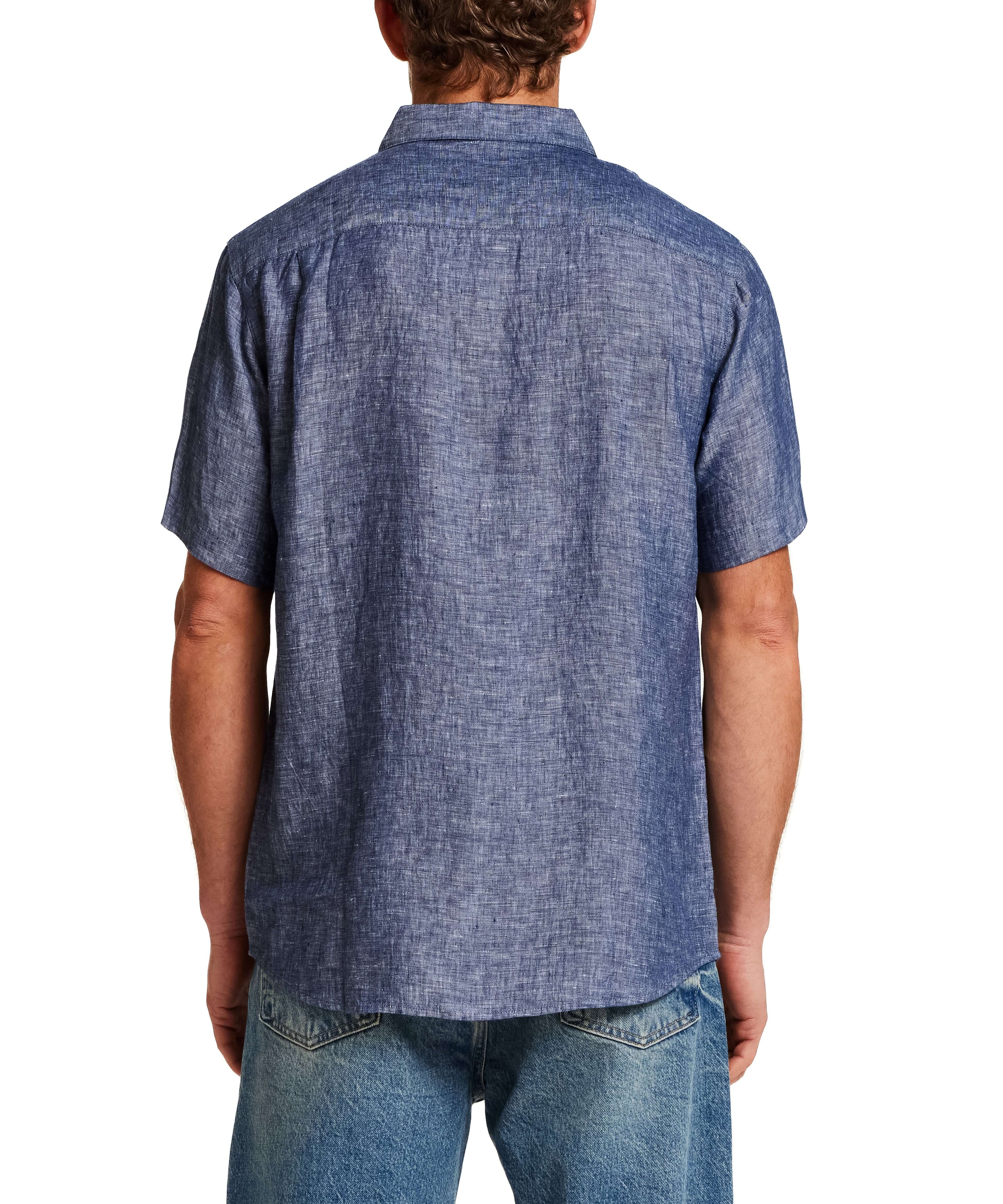 Back view of a man wearing a Short Sleeve Linen Shirt in Navy with short sleeves and a spread collar.
