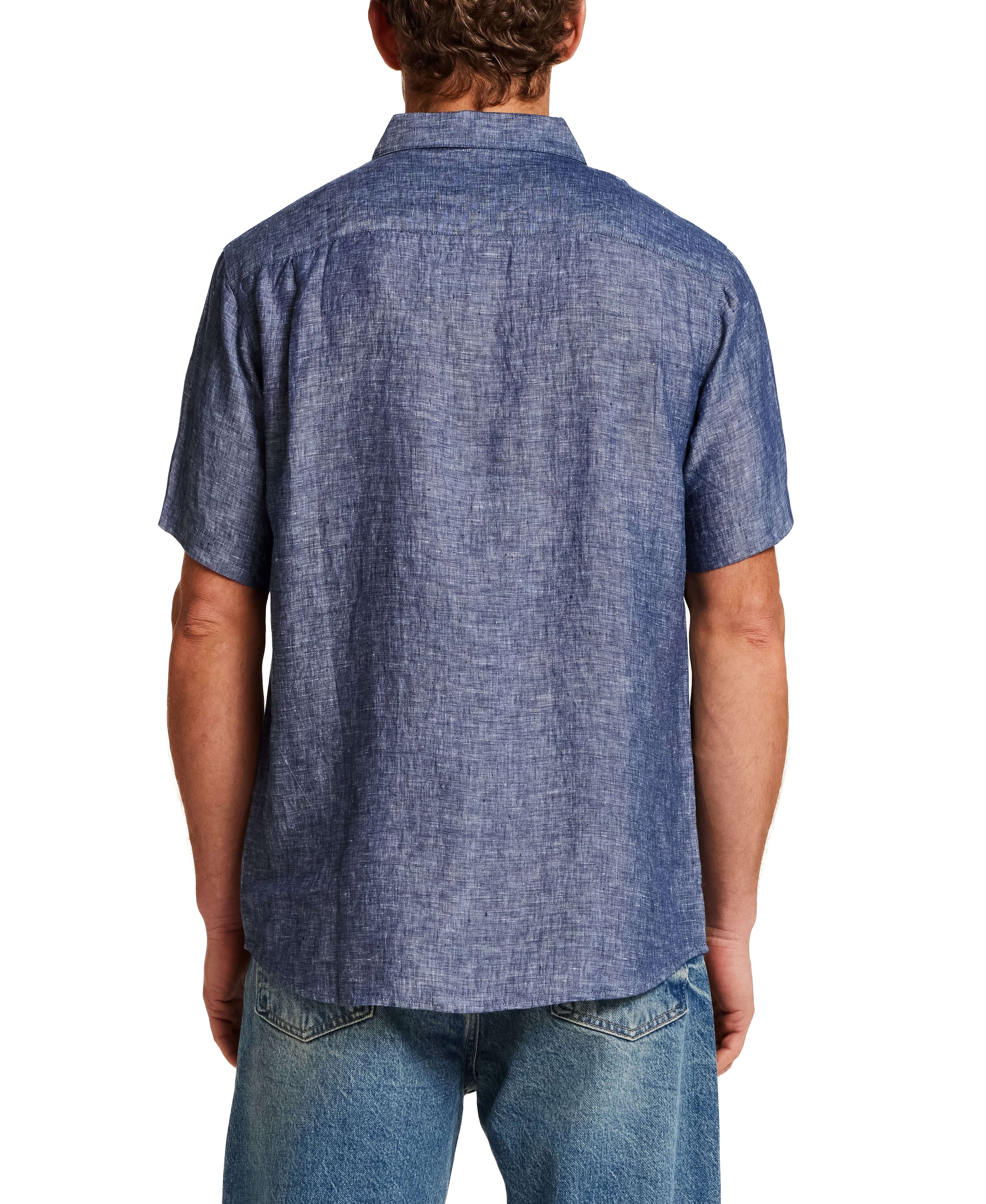 Back view of a man wearing a Short Sleeve Linen Shirt in Navy with short sleeves and a spread collar.