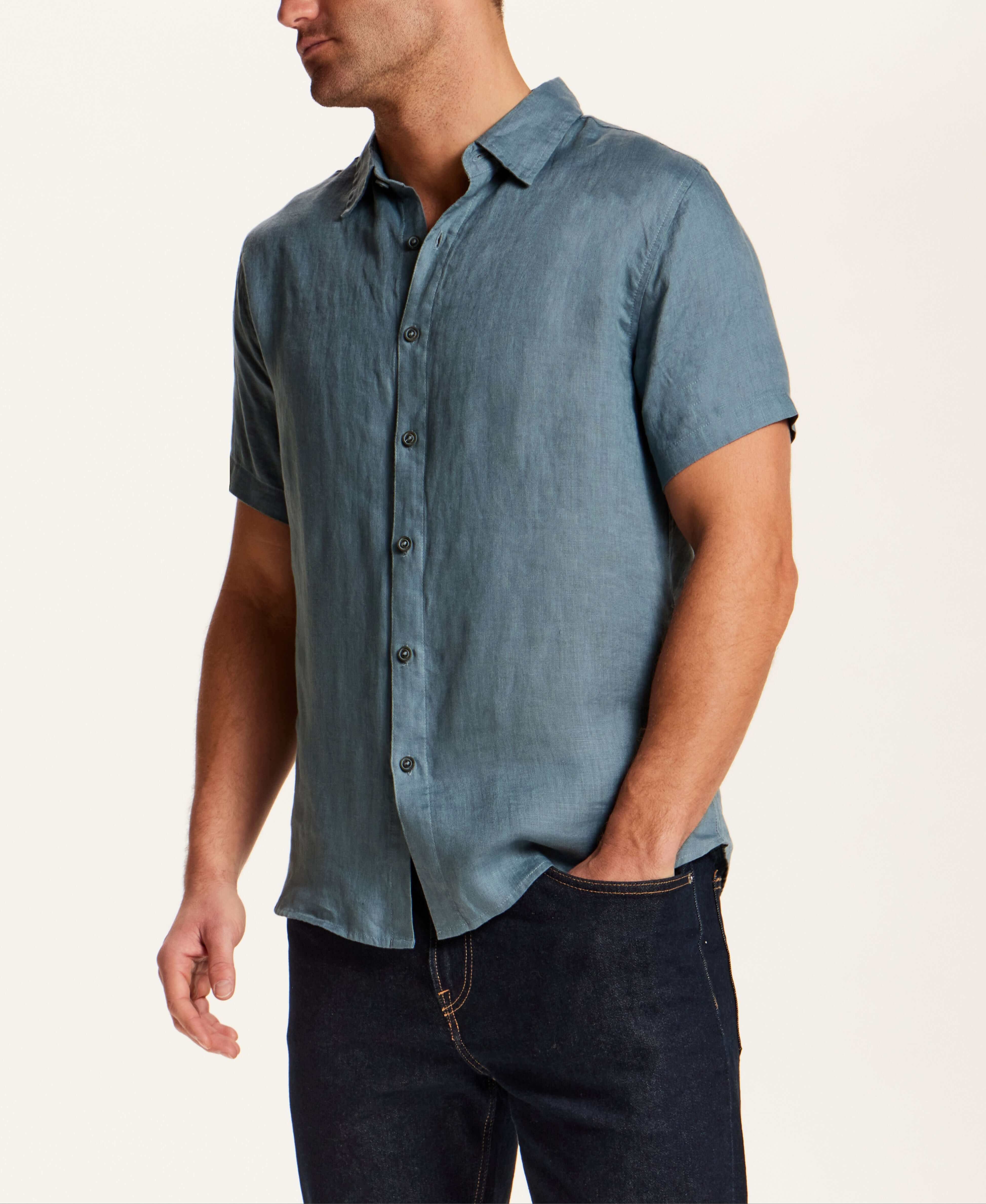 Short-Sleeve Linen Shirt in Blue worn by a man, showcasing its relaxed fit and stylish slate blue color.