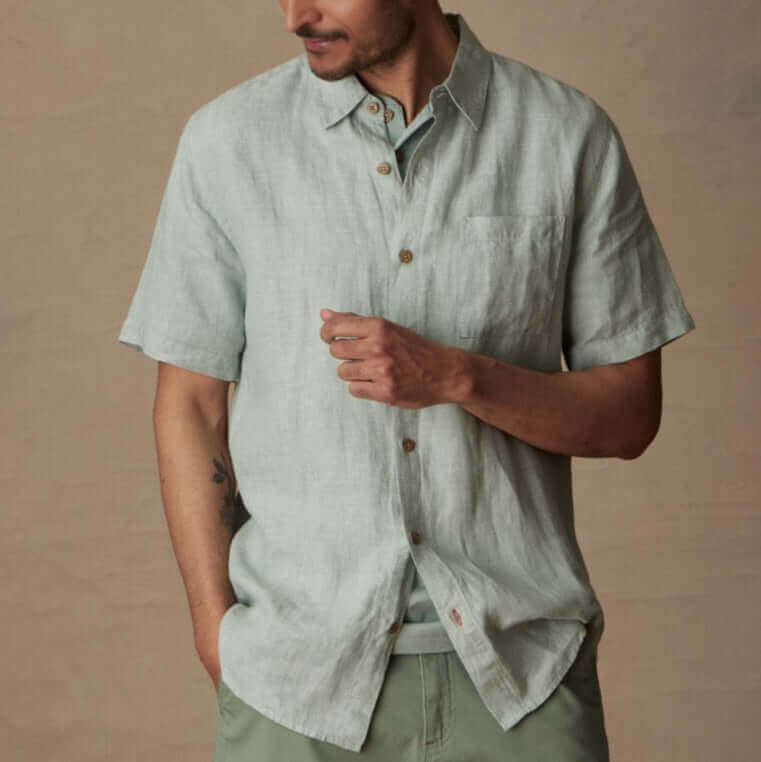 Short Sleeve Linen Shirt in Teal Mist worn by a man with a button closure and front pocket, showcasing its classic fit.