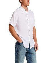 Short Sleeve Linen Shirt in White on model, featuring a chest pocket and button closure, made of 100% linen.
