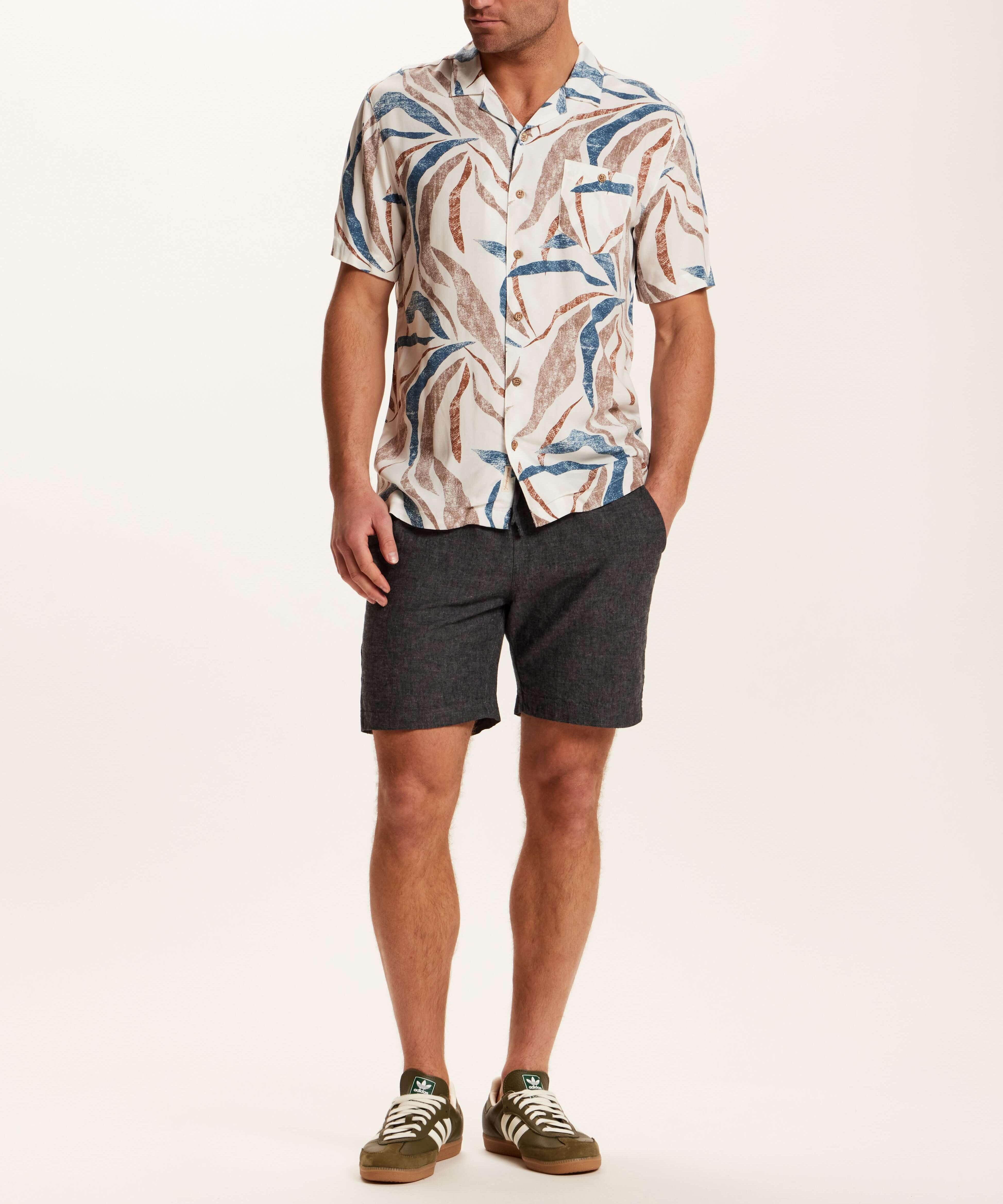 Short Sleeve Rayon Printed Camp Shirt in Marsala styled with shorts and casual shoes, showcasing a retro pattern.