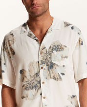 Short Sleeve Rayon Printed Camp Shirt in Putty worn by a model, showcasing a retro floral pattern and camp collar.
