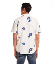 Back view of model wearing Short Sleeve Seersucker Print in Victoria Blue shirt with floral design.