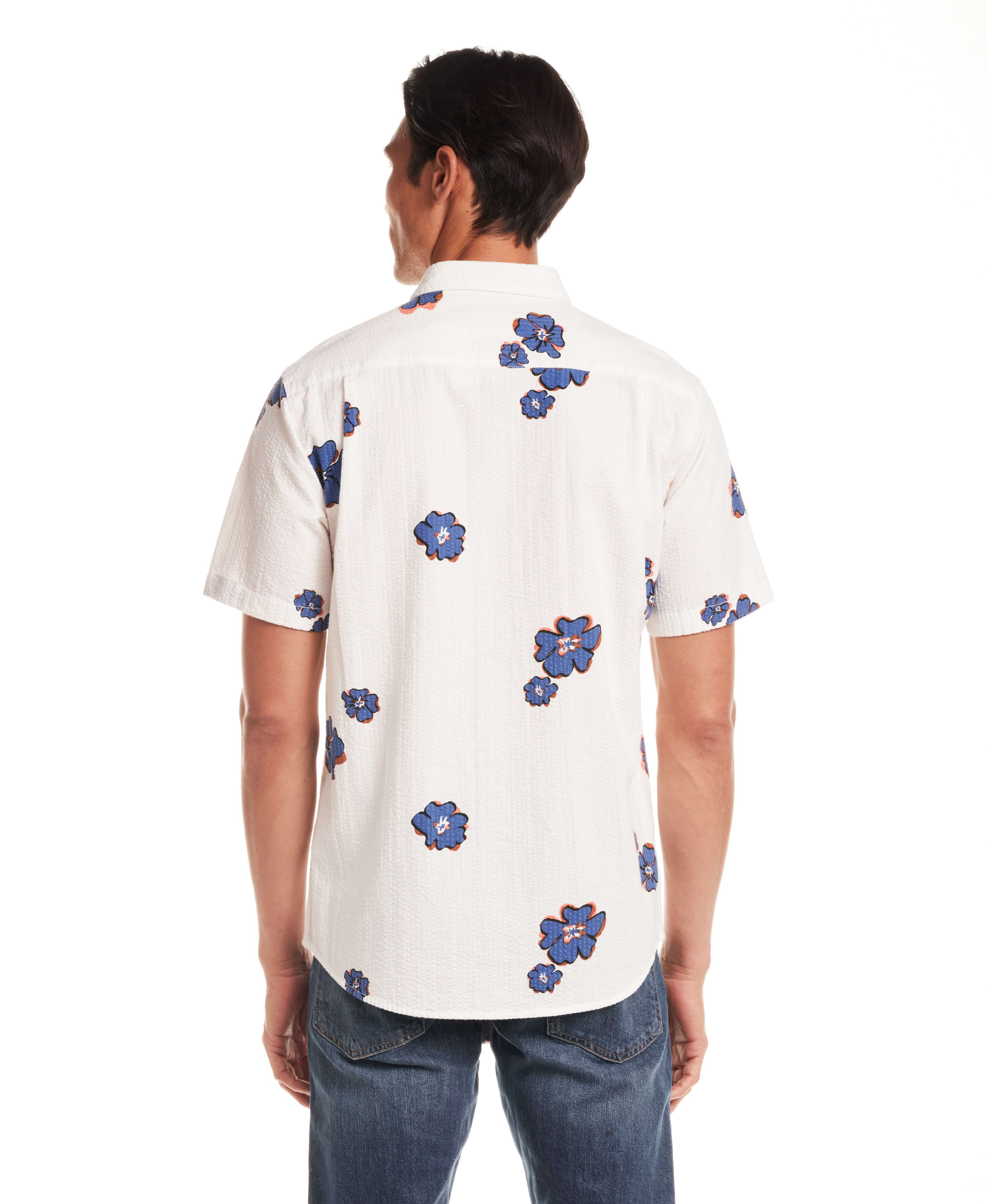 Back view of model wearing Short Sleeve Seersucker Print in Victoria Blue shirt with floral design.