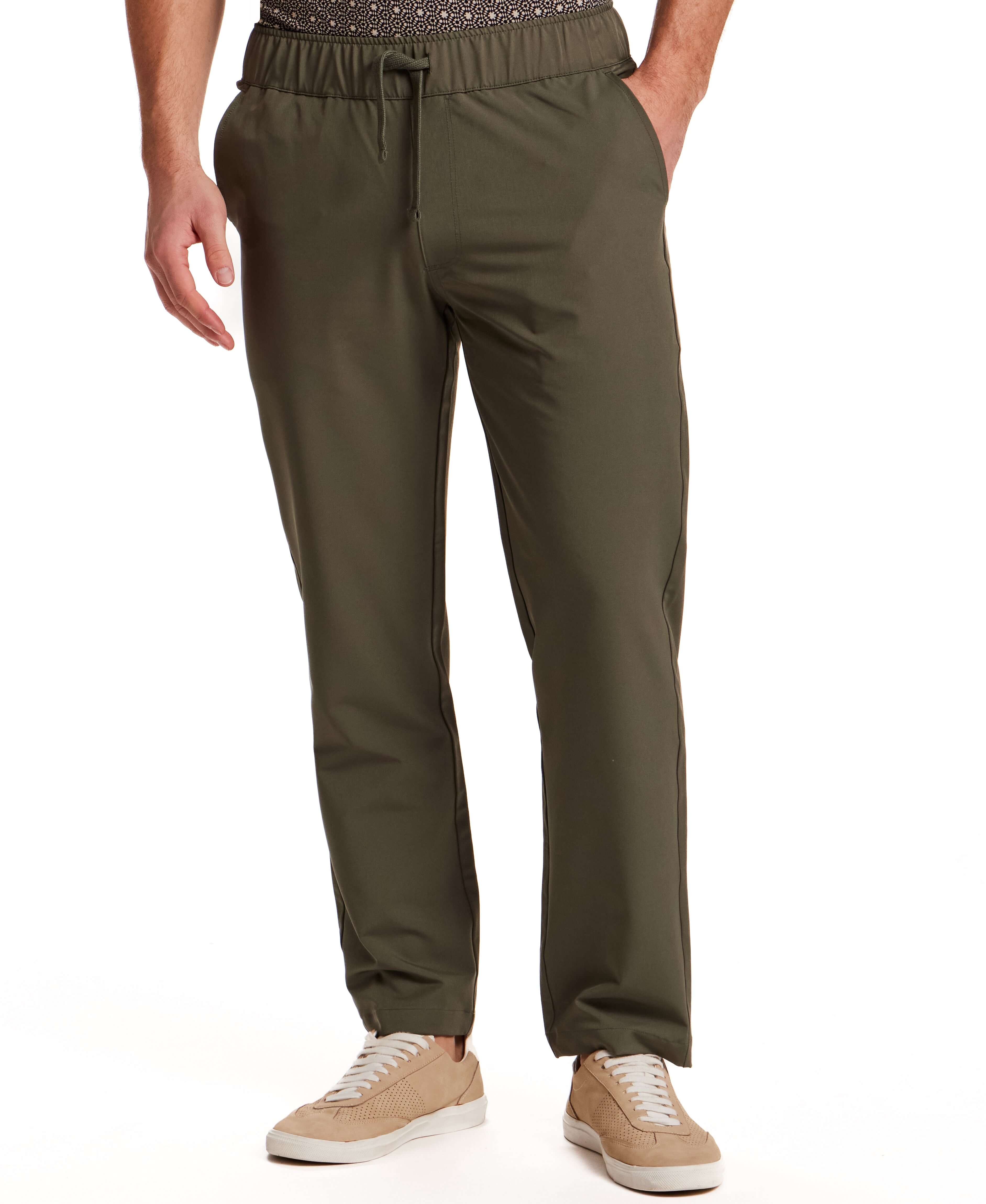 The Tech Jogger in Olive worn by a model, showcasing a smooth stretch blend and elastic waistband.