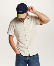 Textured Horizontal Stripe Button-Down Shirt in Turtle Dove modeled by a man wearing a cap and denim.