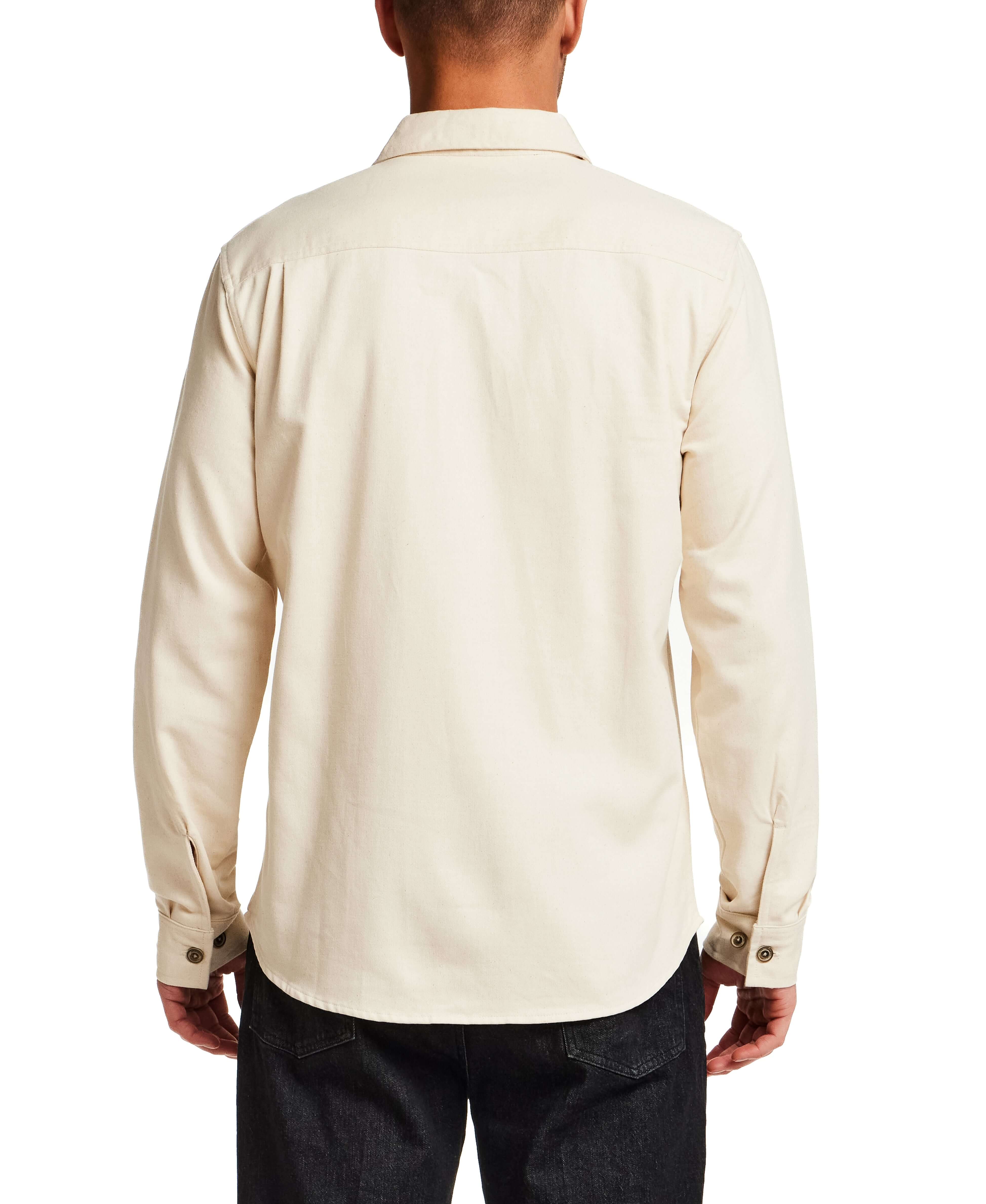 Back view of The Utility Shirt in Natural, showcasing its classic design and button detailing.