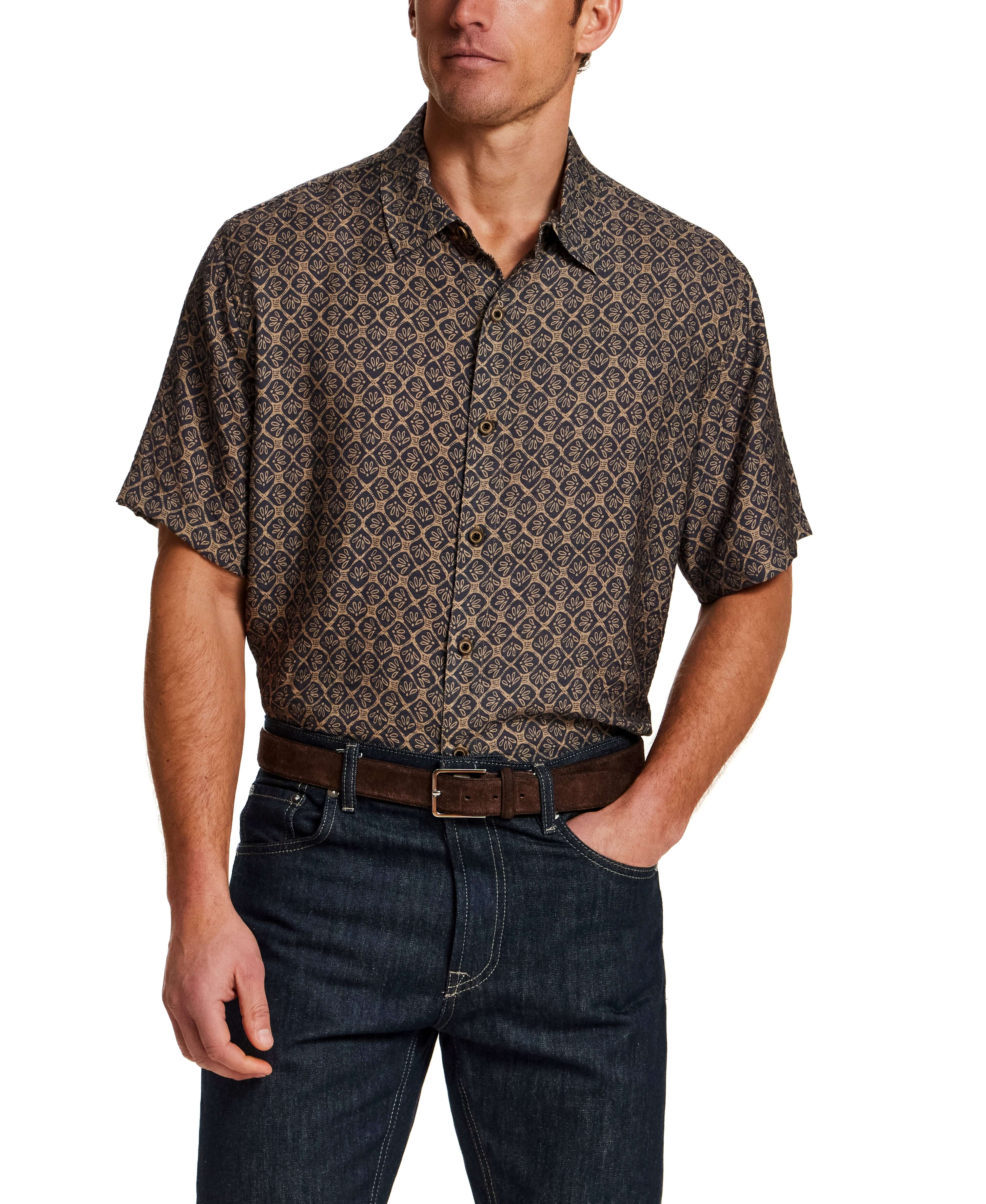 Model showcasing a Petal Print Short-Sleeve Shirt with a relaxed fit and button front, styled with dark jeans.