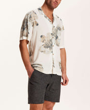 Short Sleeve Rayon Printed Camp Shirt in Putty worn by a model, featuring a retro floral pattern and trendy camp collar.