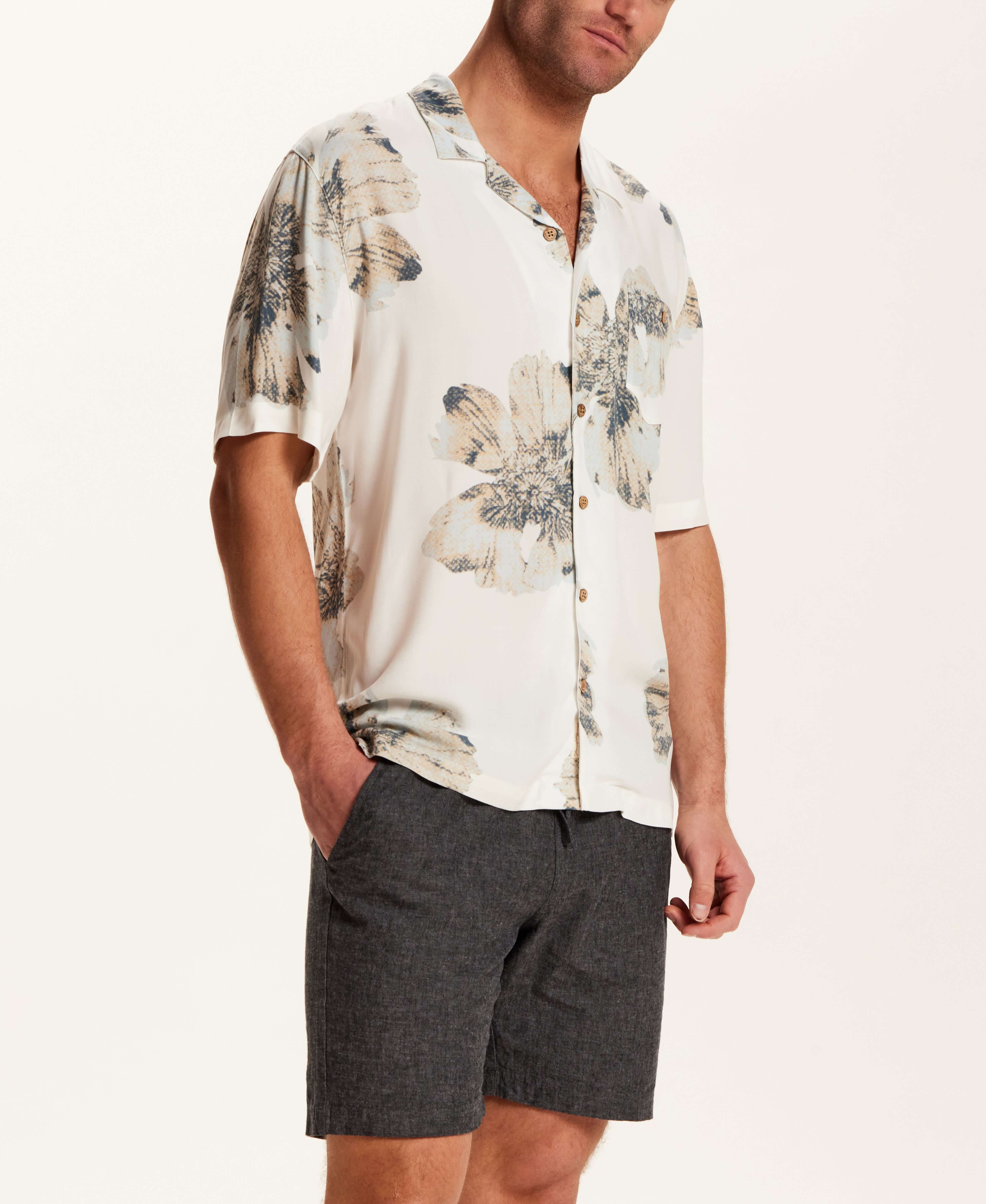 Short Sleeve Rayon Printed Camp Shirt in Putty worn by a model, featuring a retro floral pattern and trendy camp collar.