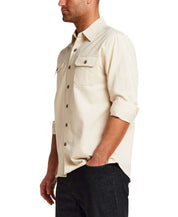 The Utility Shirt in Natural worn by a model, showcasing a button front and flap chest pockets.