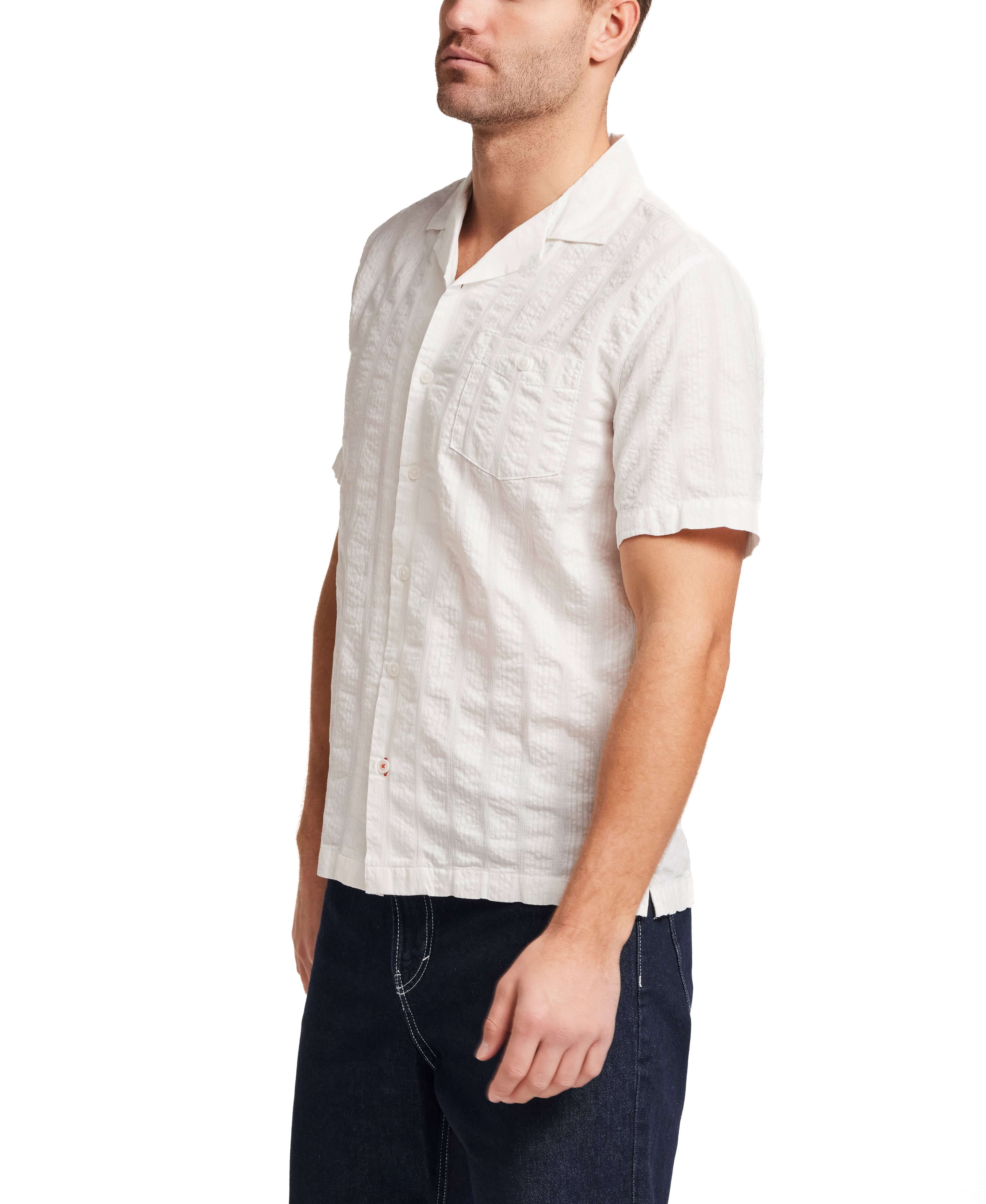 Model wearing Cotton Dobby Seersucker Shirt in White, showcasing a relaxed fit and breathable fabric.