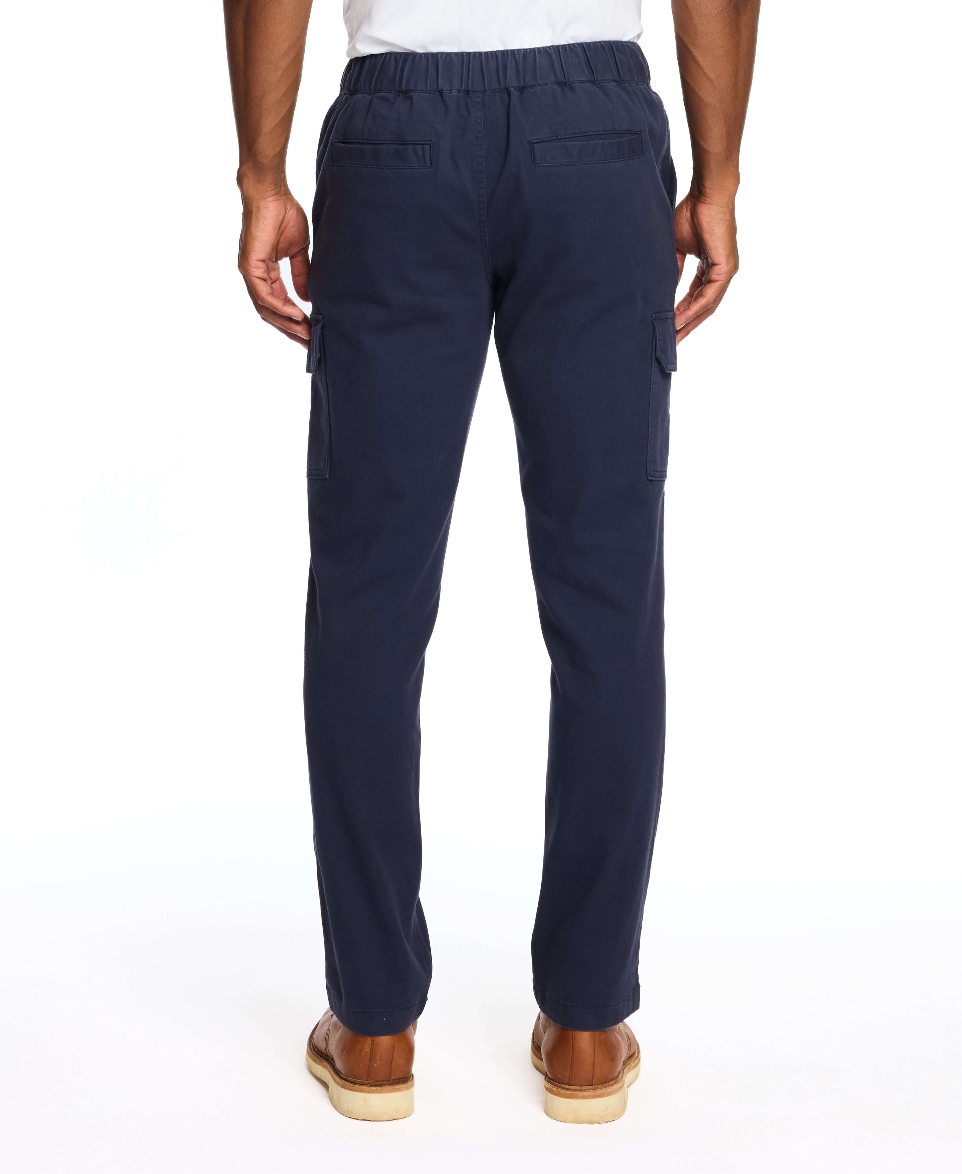 Men's navy cargo pants with stretch waist and side pockets, showcasing a comfortable fit from the back.
